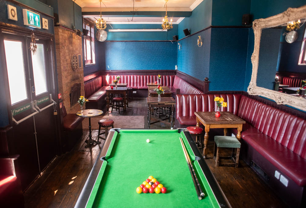 Stylish Function Room at The Chequers with blue walls, perfect for meetings and events.