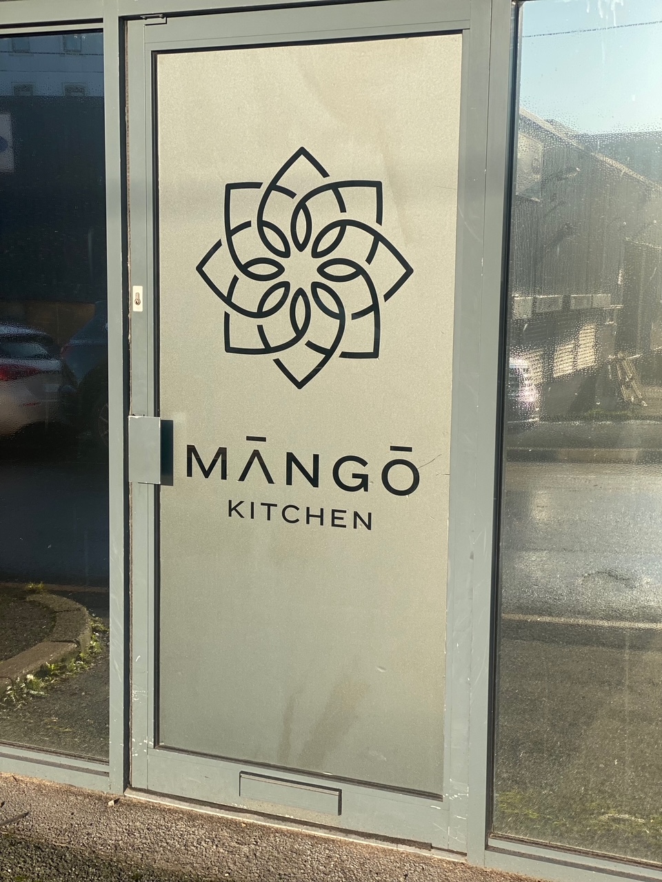 Māngō Kitchen sign in modern dining room, perfect for events and receptions.