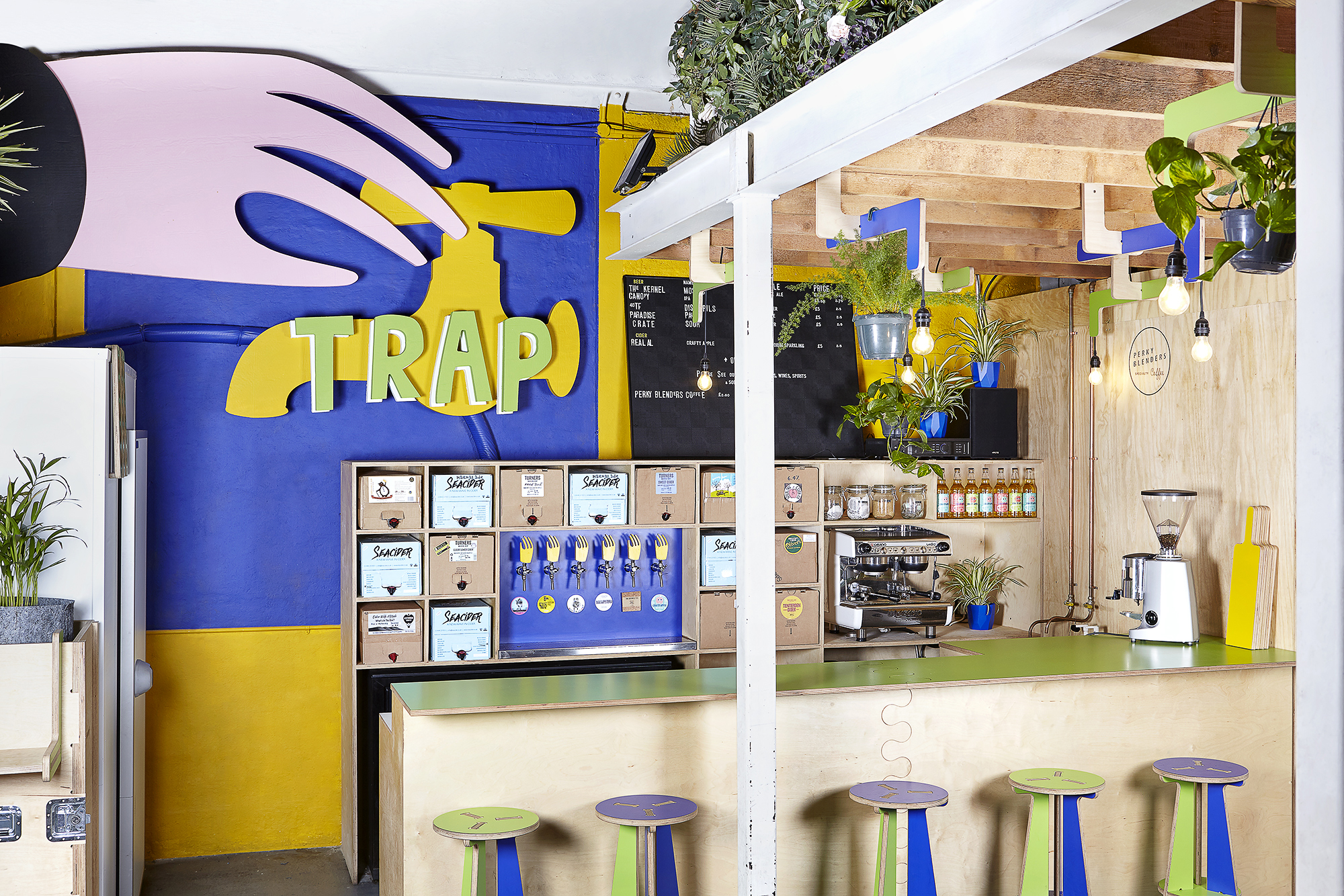 Vibrant taproom with colorful decor, perfect for networking events and casual meetings.