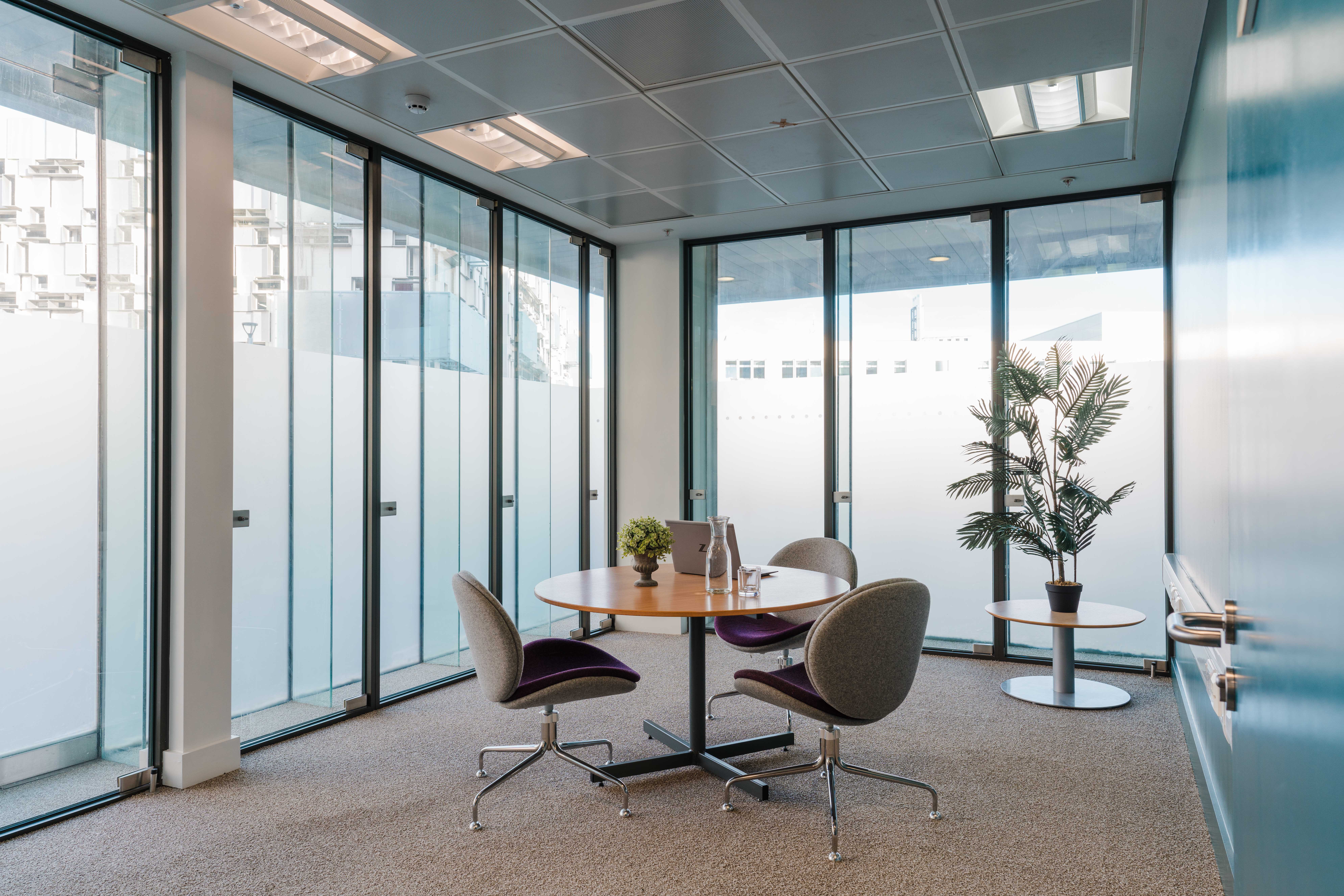 Modern meeting space at Millennium Point with round table, ideal for gatherings and brainstorming.