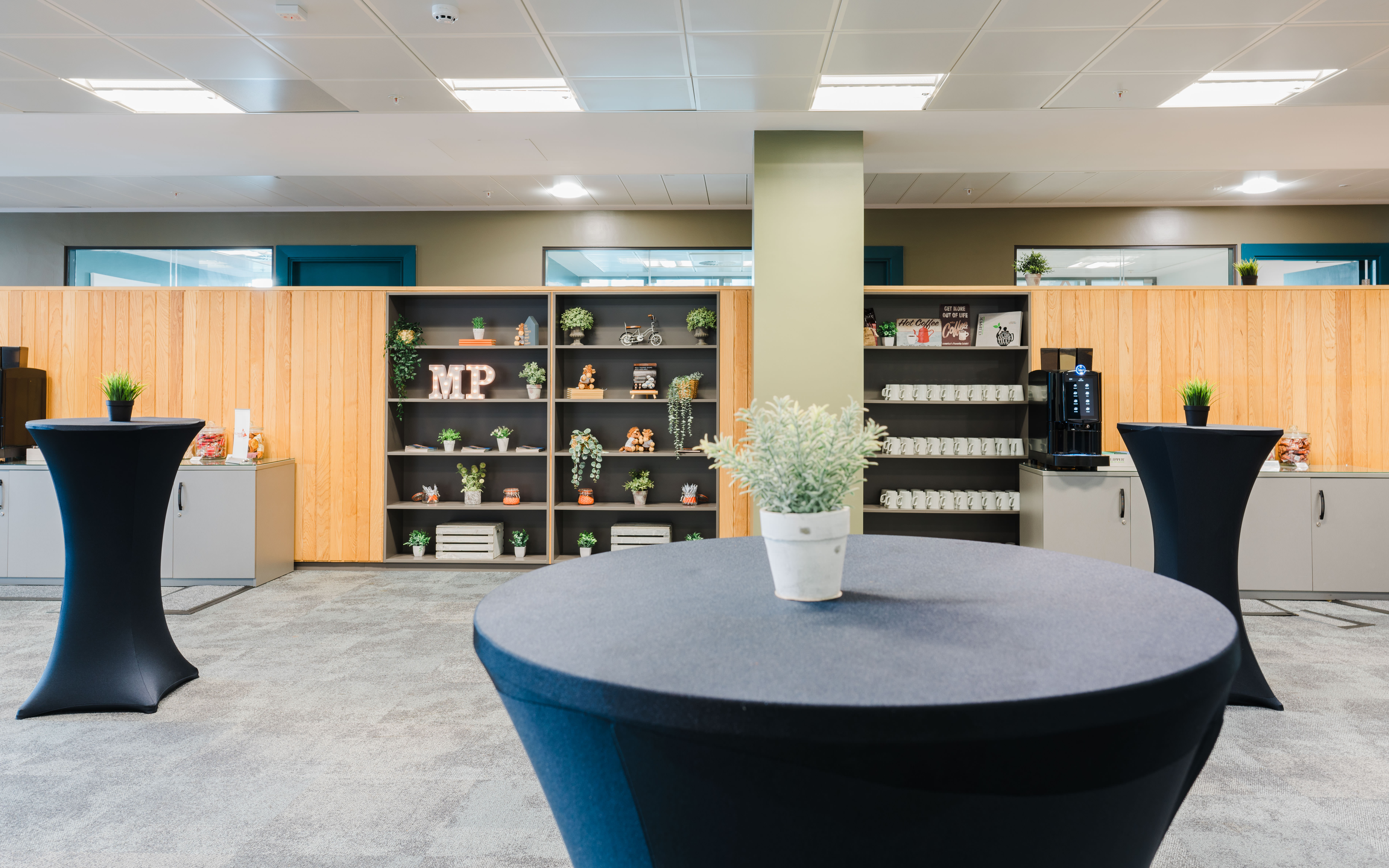 Modern event space at Millennium Point with sleek high-top tables for networking.