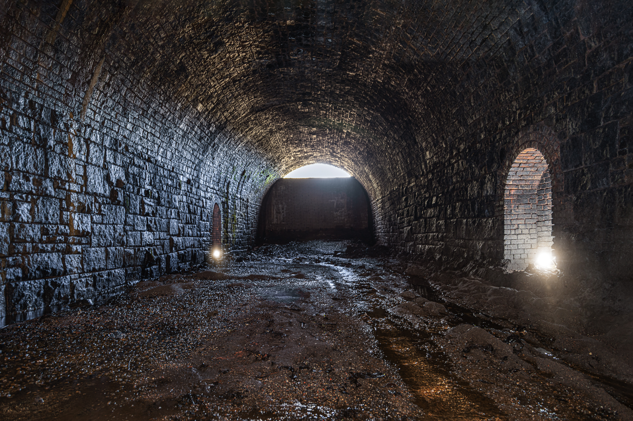 Disused railway tunnel with textured stone walls, perfect for atmospheric events.