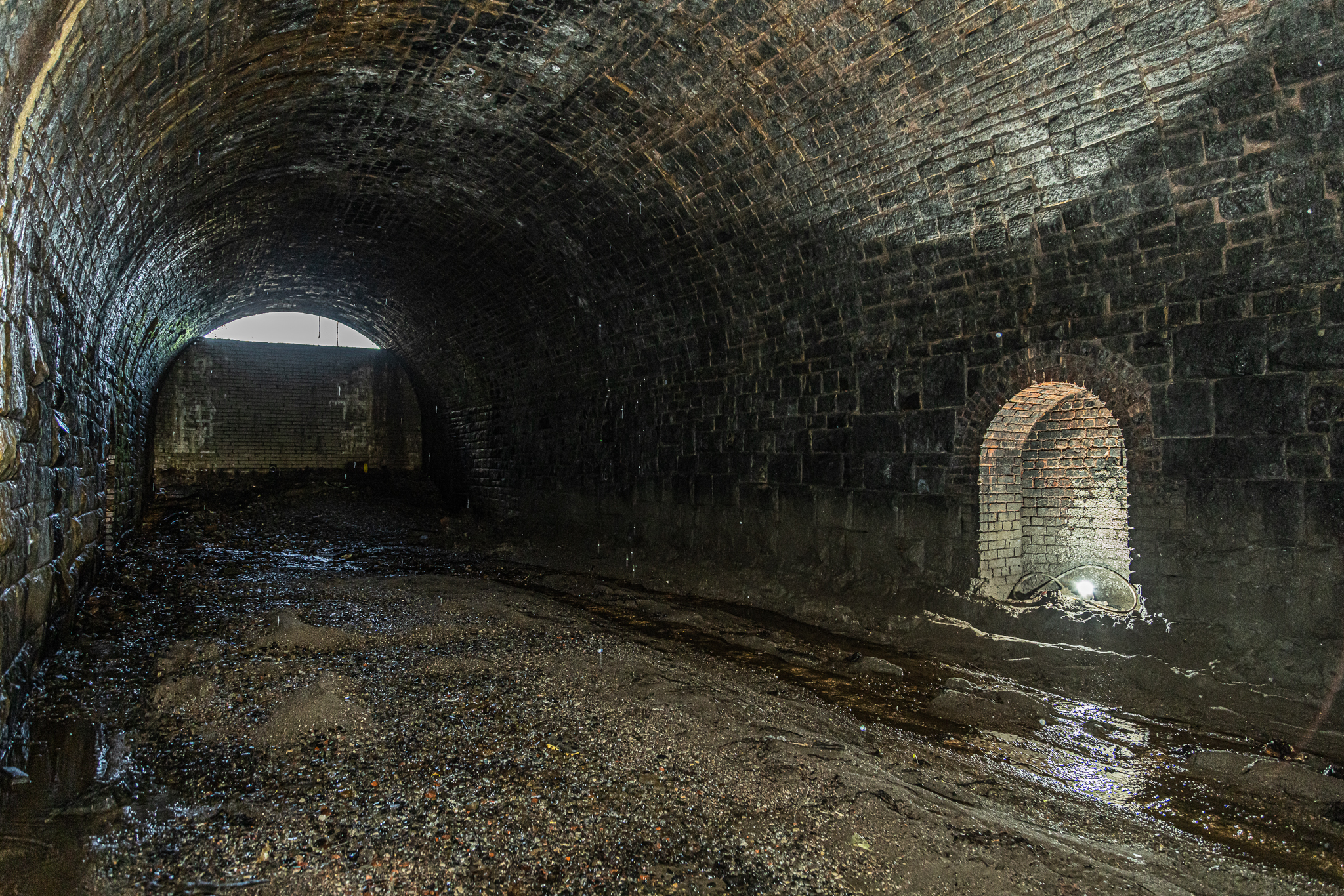 Disused railway tunnel with stone walls, ideal for immersive events and gatherings.