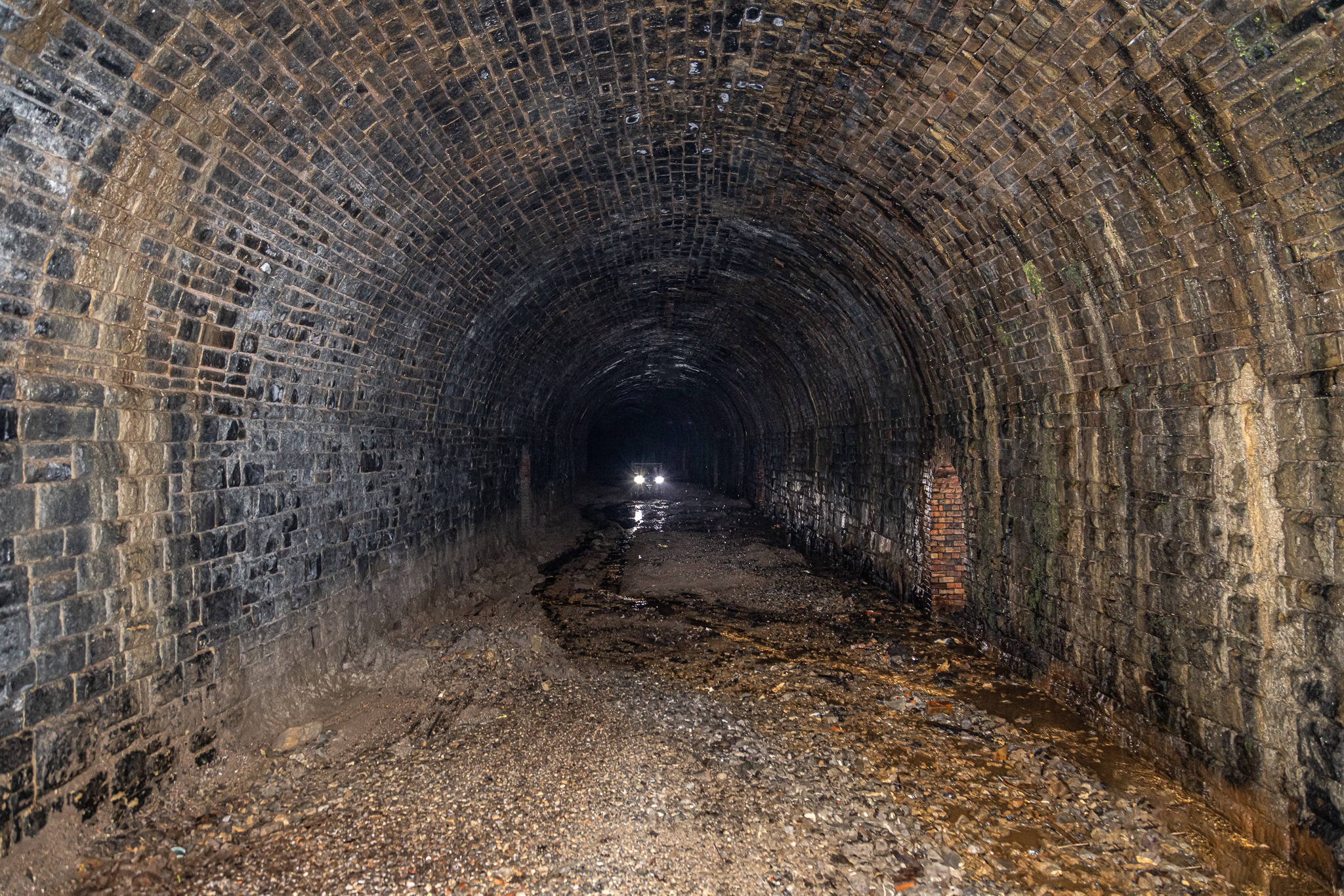 Disused railway tunnel with brick walls, ideal for immersive events and unique experiences.
