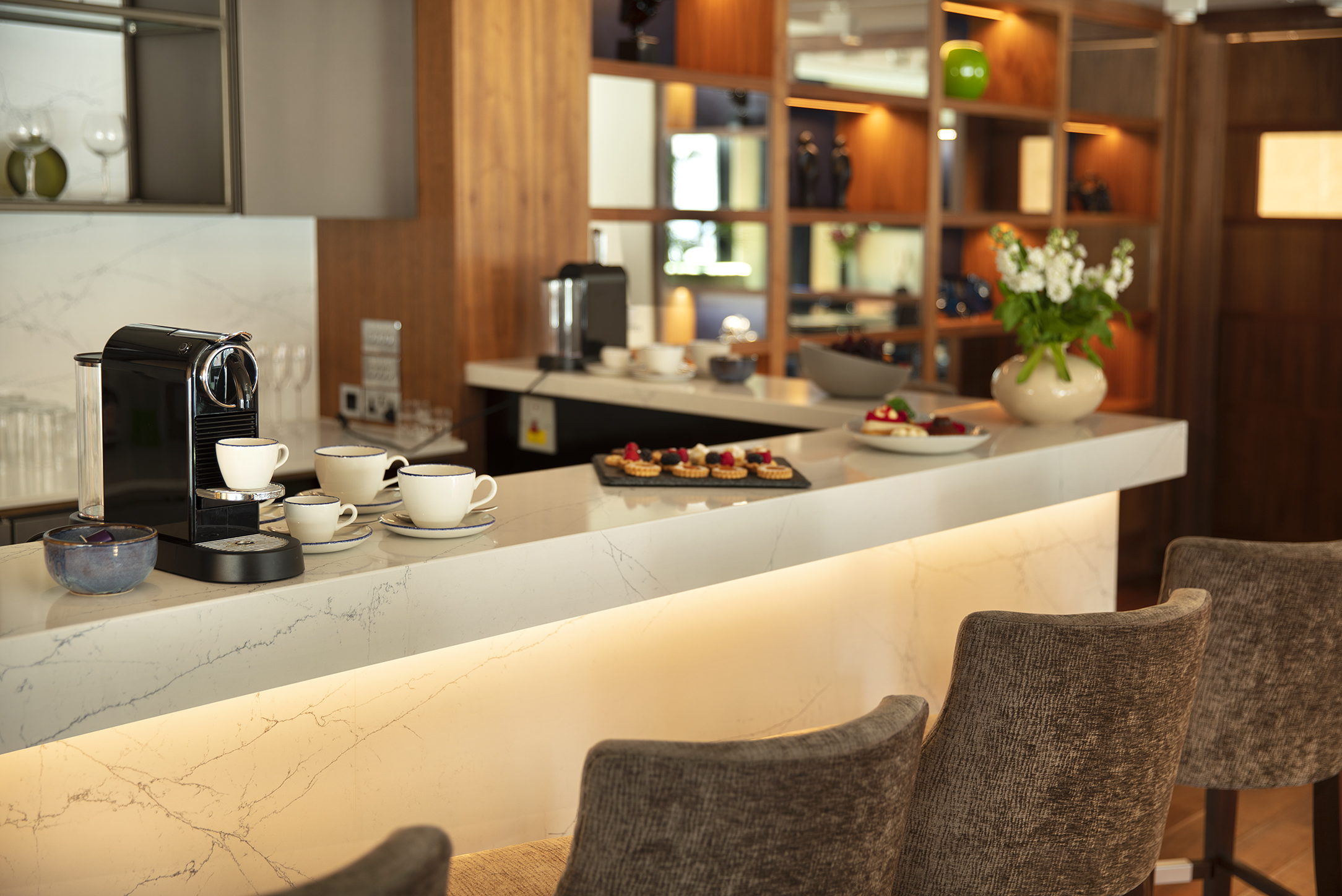 Crescent Suite refreshment area with marble countertop for networking events and meetings.