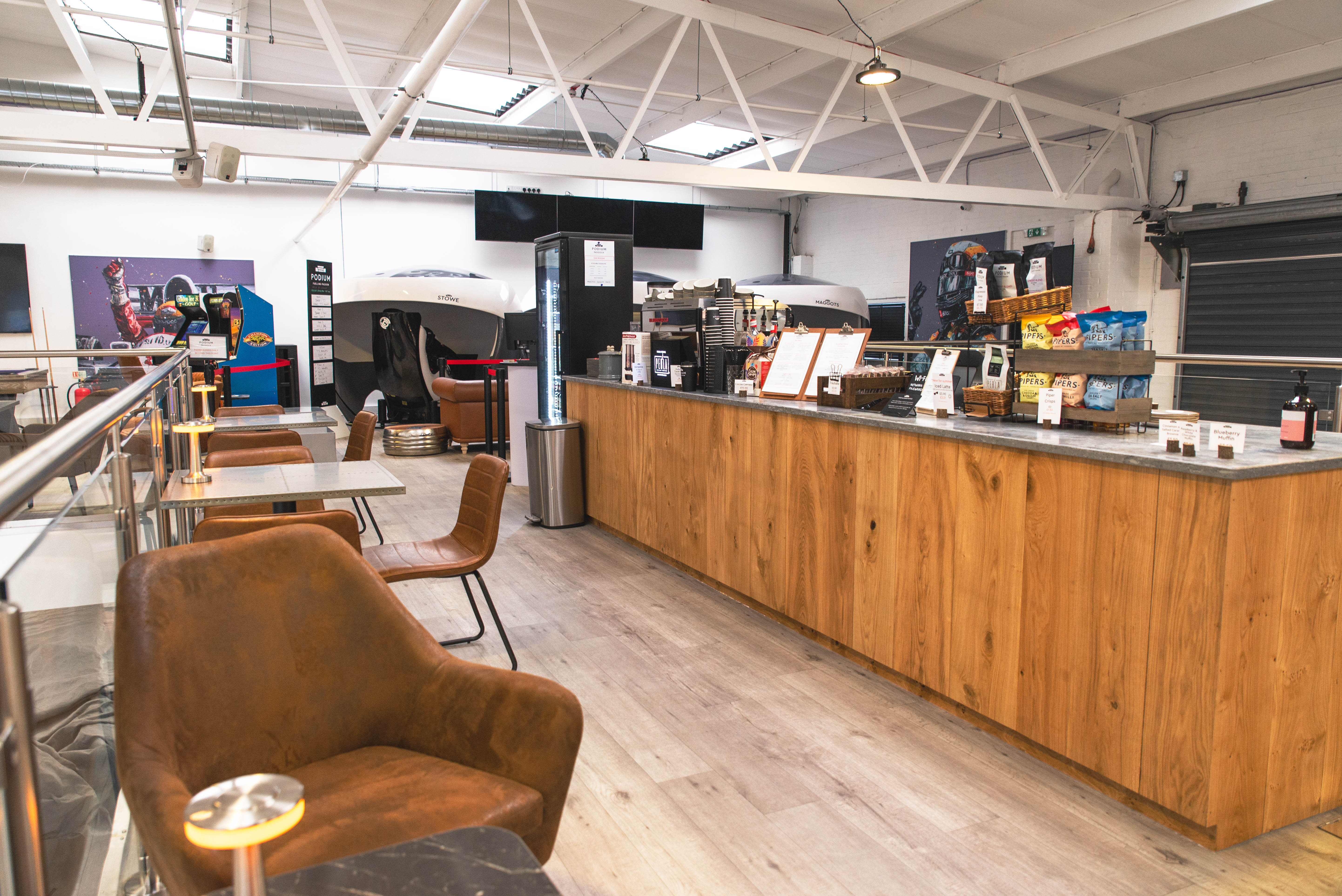 Modern café space with wooden counter, ideal for networking events and meetings.