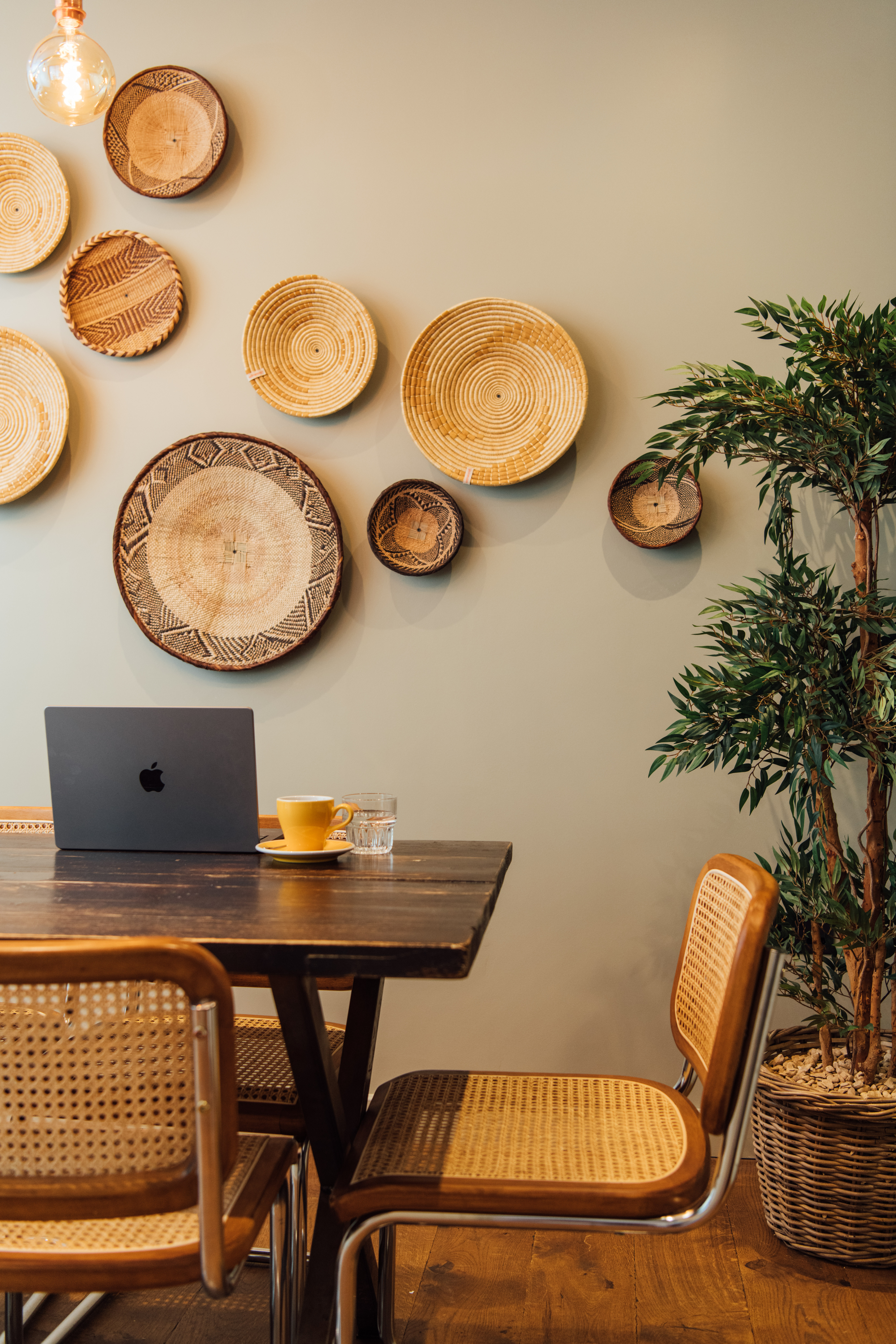 Cozy meeting space with coffee and laptop at Hermitage Rd Coffee & Bagel Bar.