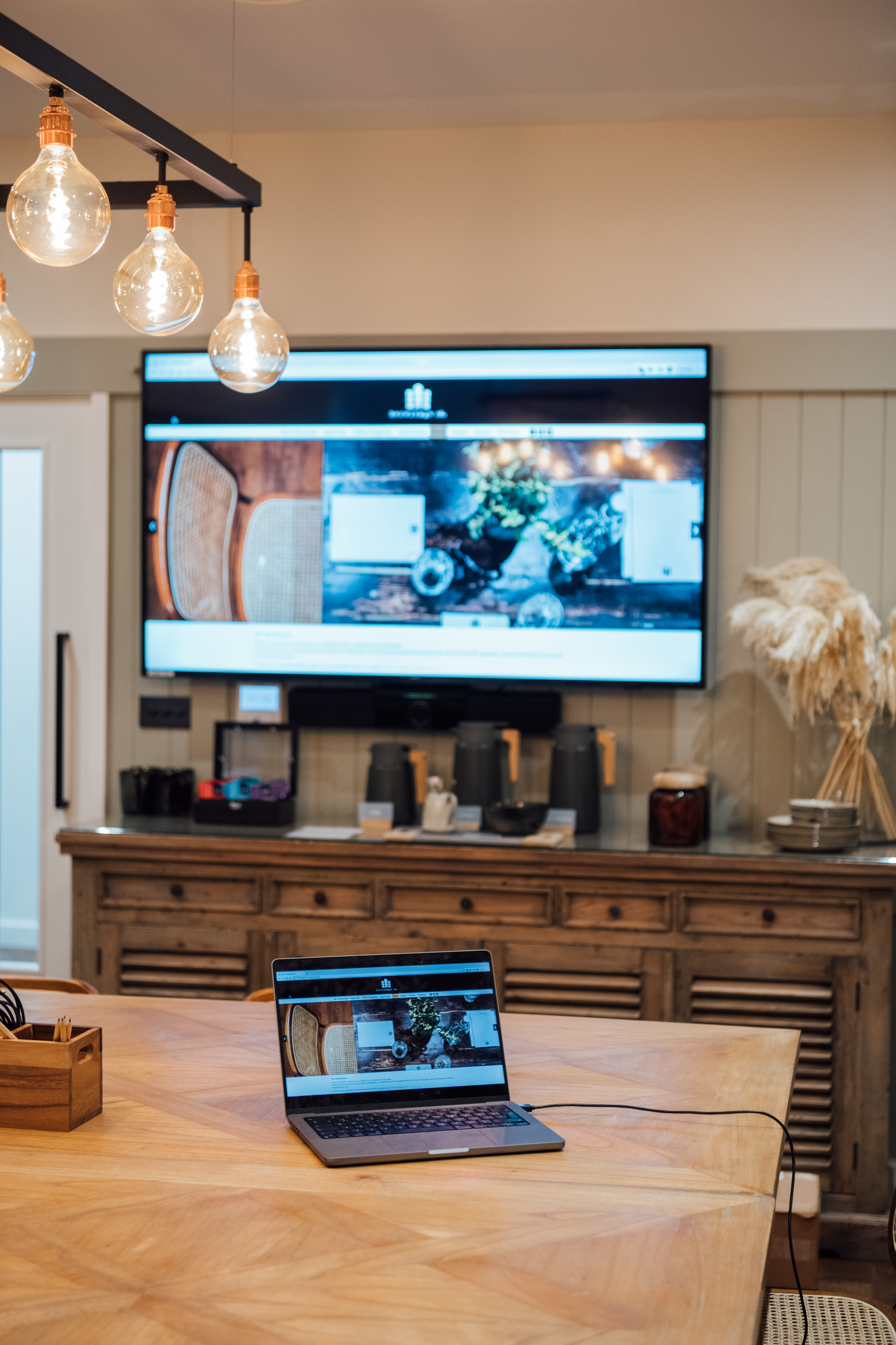 Meeting space at Hermitage Rd Coffee & Bagel Bar with large screen, ideal for workshops.