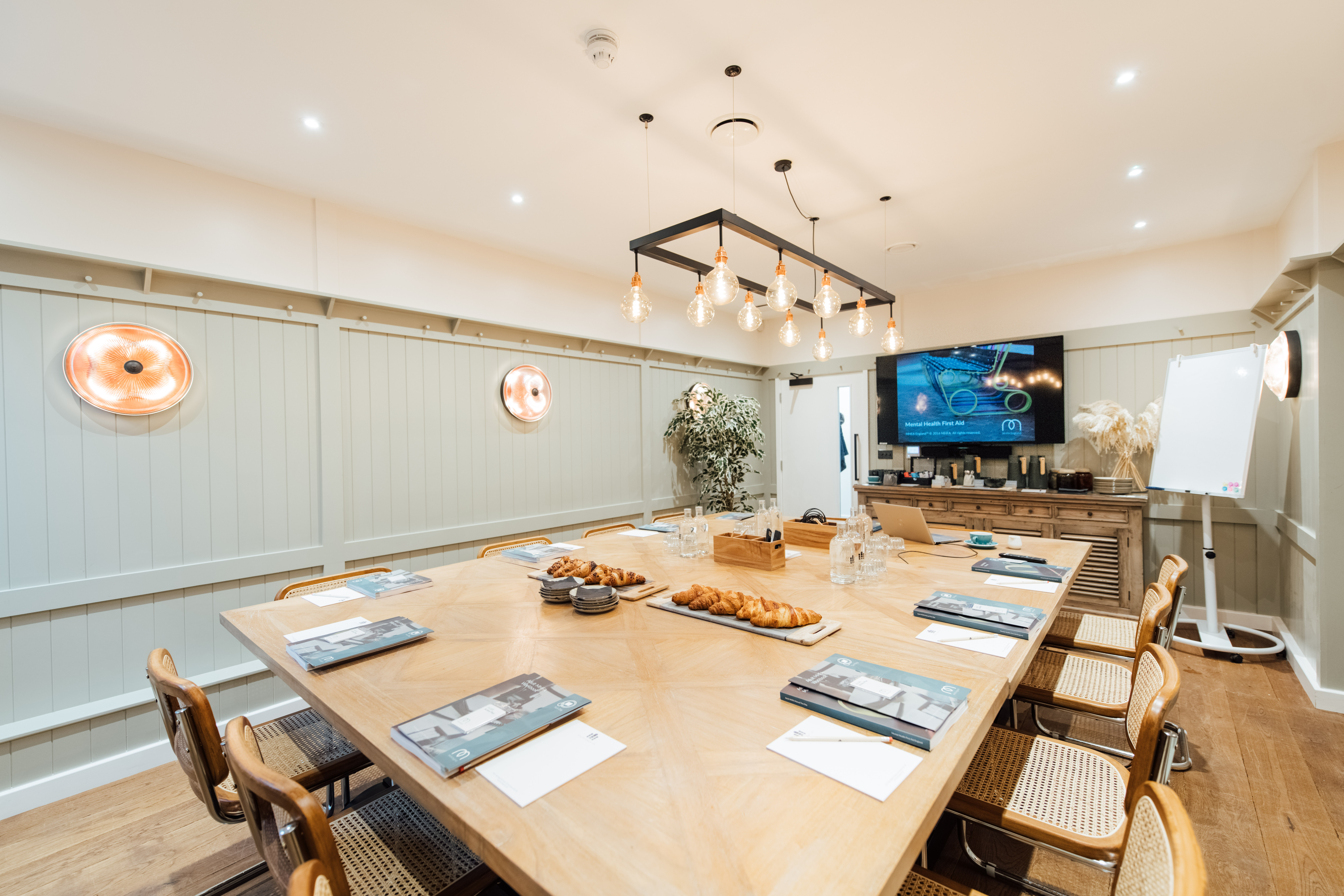 Meeting room at Hermitage Rd Coffee & Bagel Bar, featuring a large wooden table for workshops.