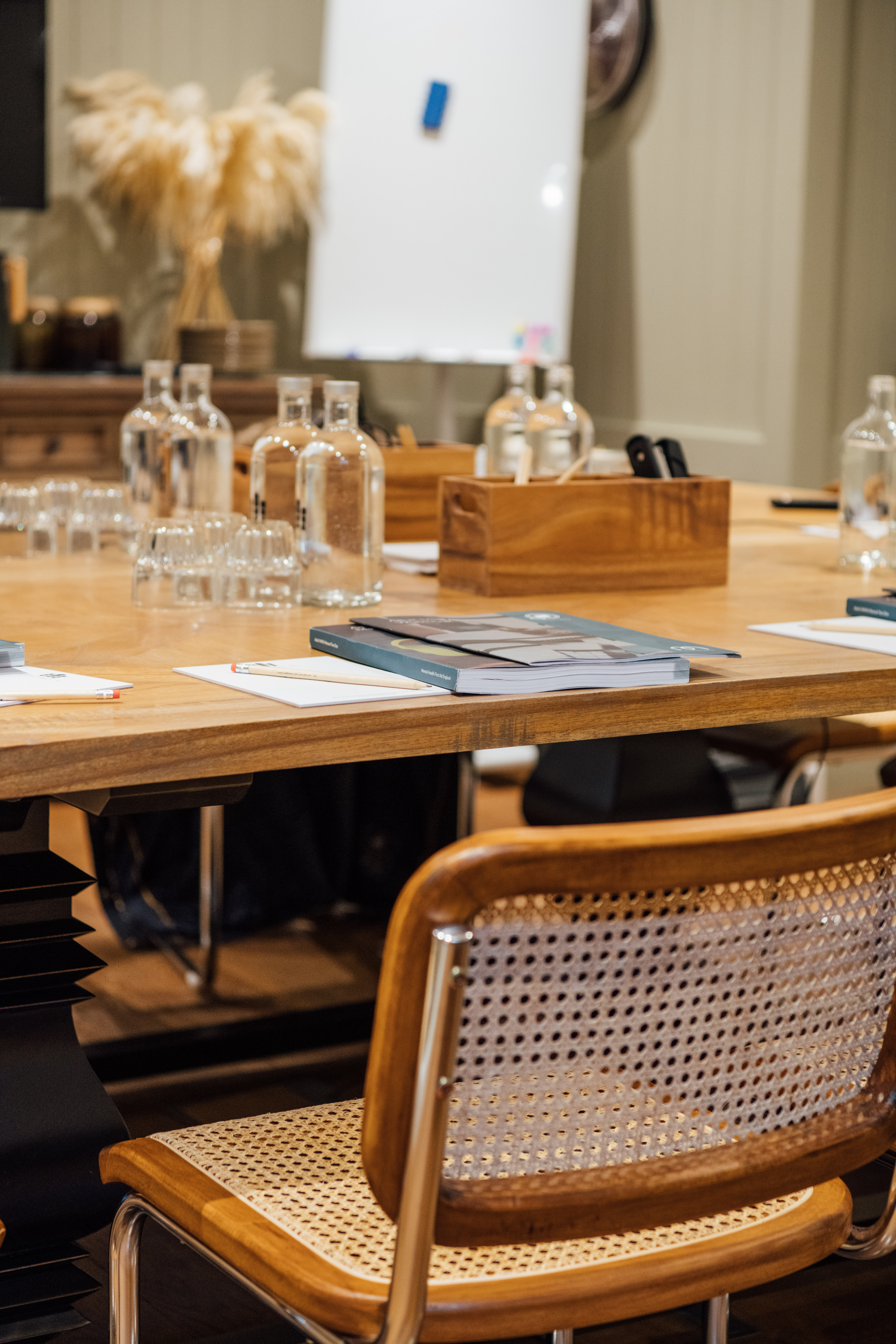 Professional meeting setup at Hermitage Rd Coffee & Bagel Bar with polished wooden table.