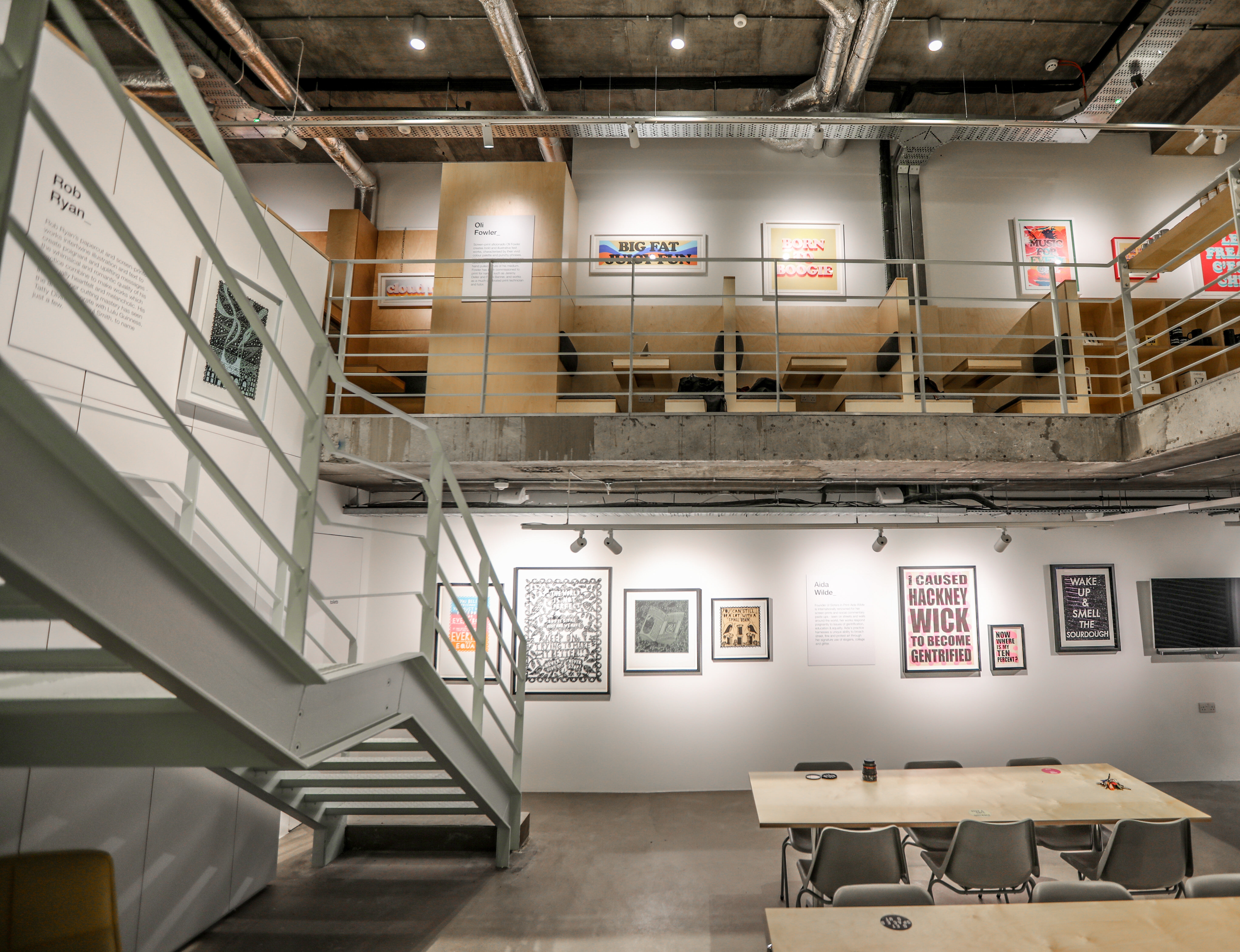 Modern industrial event space with gallery walls, ideal for meetings and workshops.