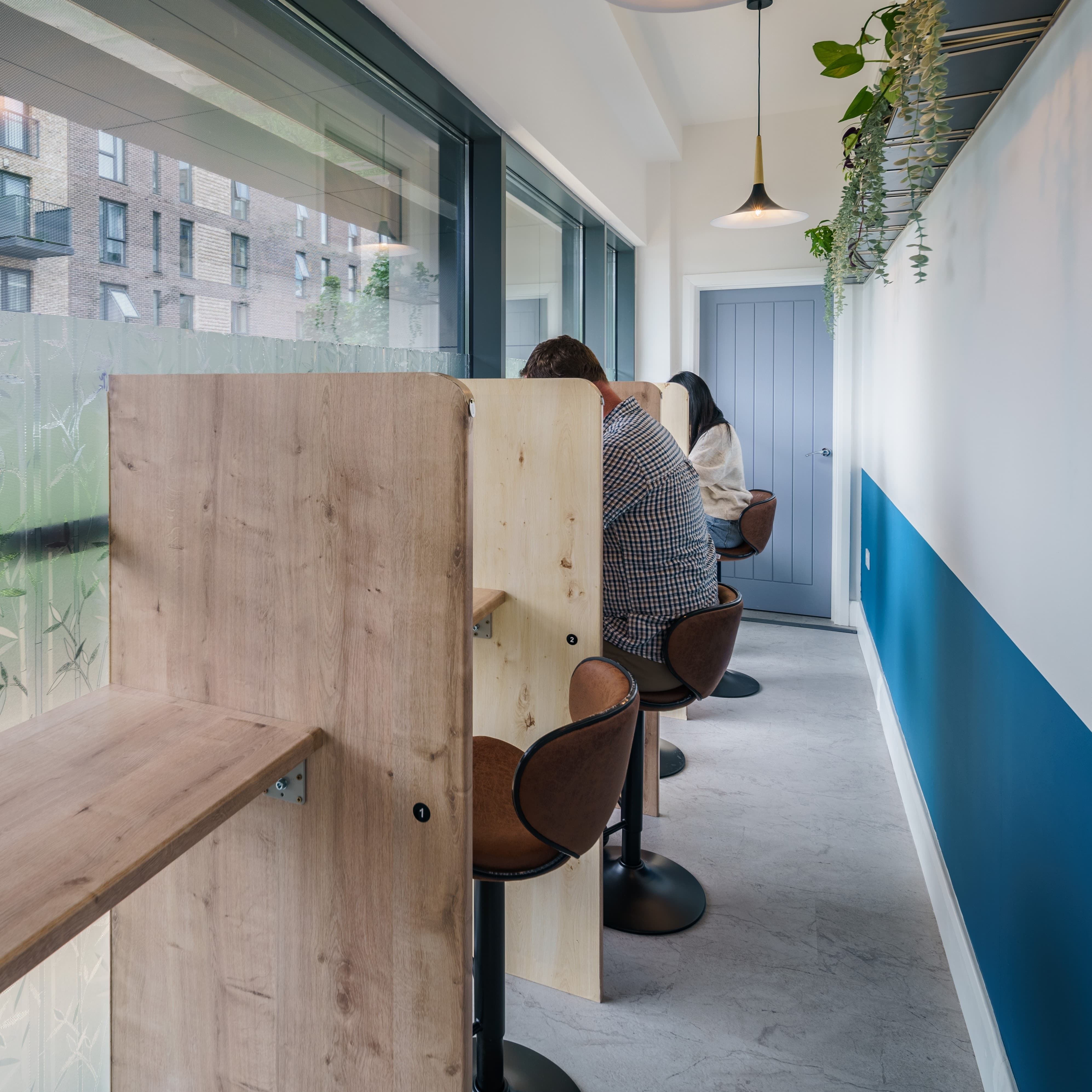 Modern hybrid meeting space with private booths for focused collaboration and productivity.