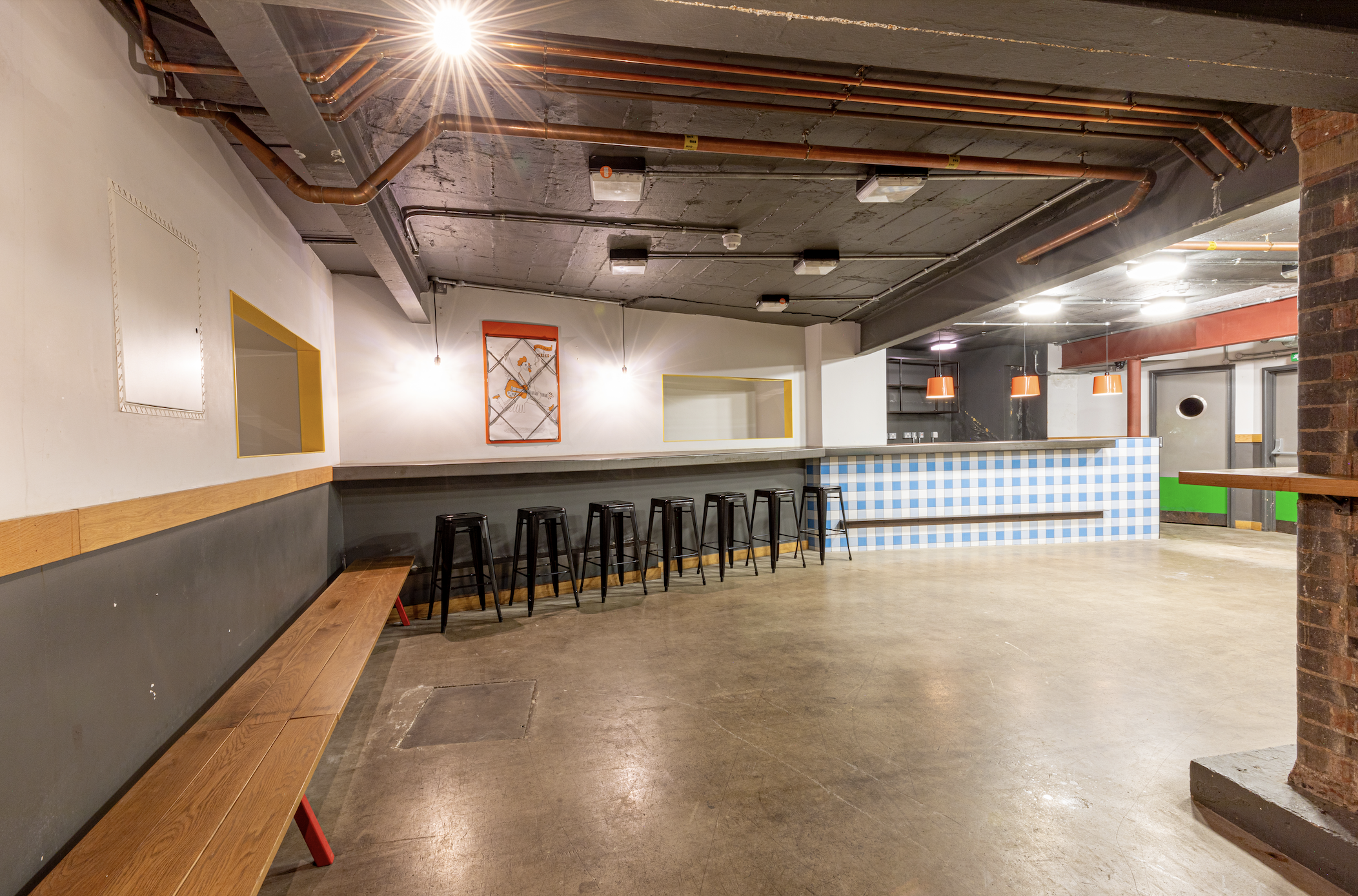 Versatile industrial event space with polished concrete floors for meetings and gatherings.