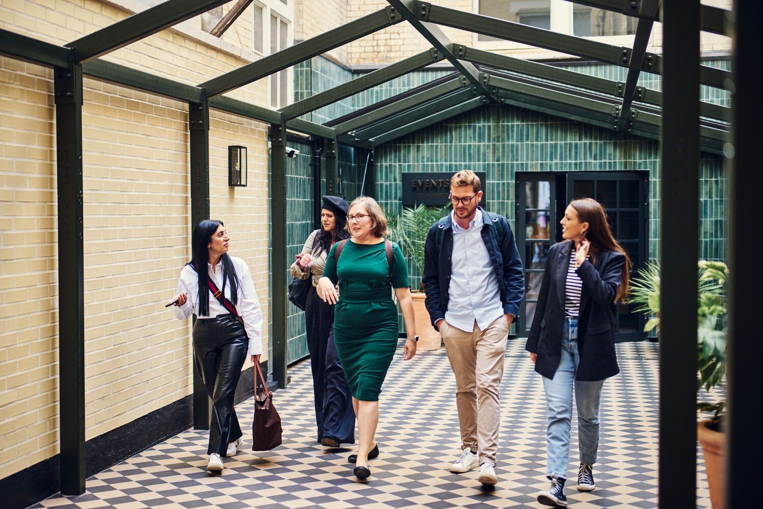 Professionals networking in a stylish corridor at Salisbury House event venue.