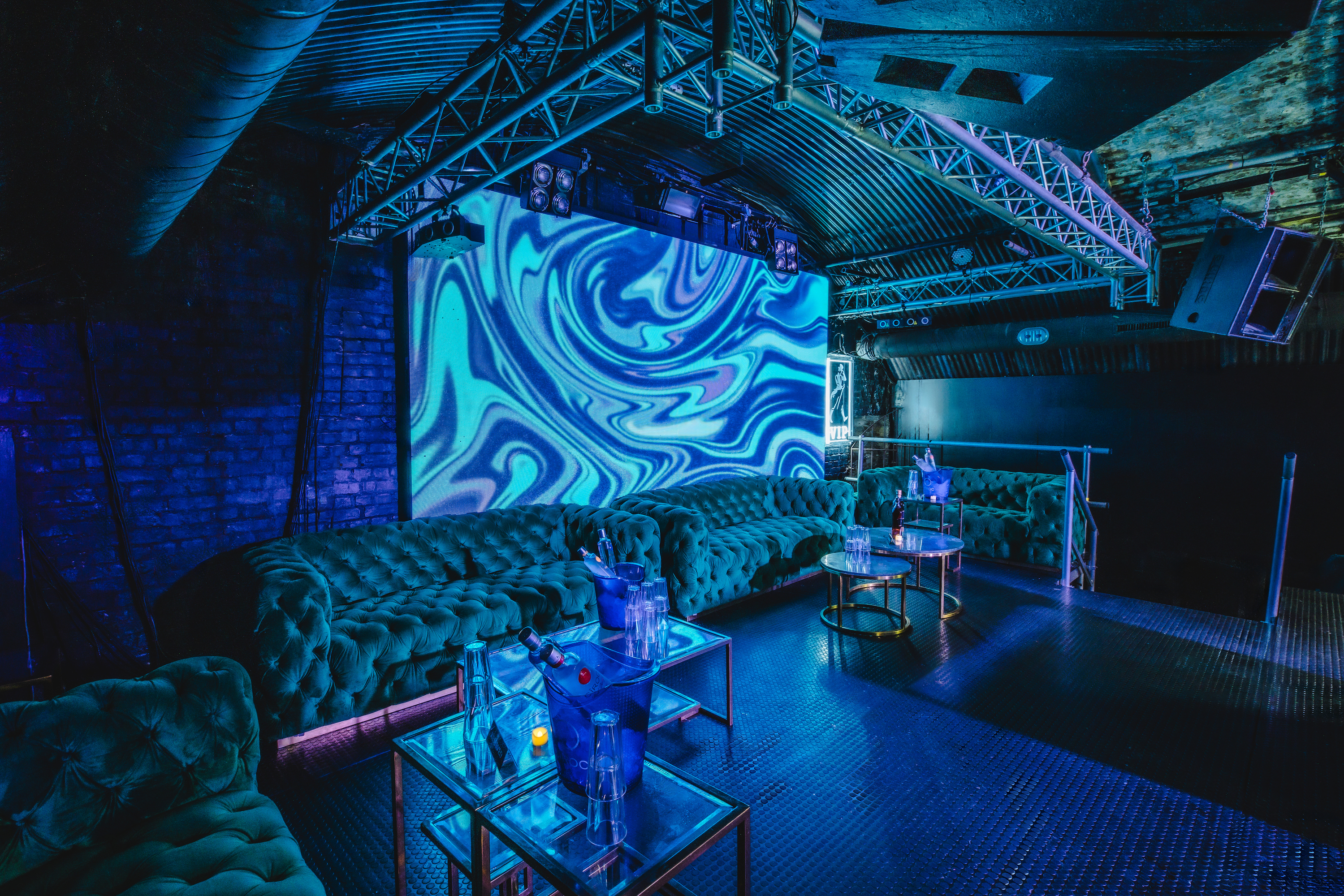 Fire Mirror Arch event space with plush seating, ideal for networking and private parties.