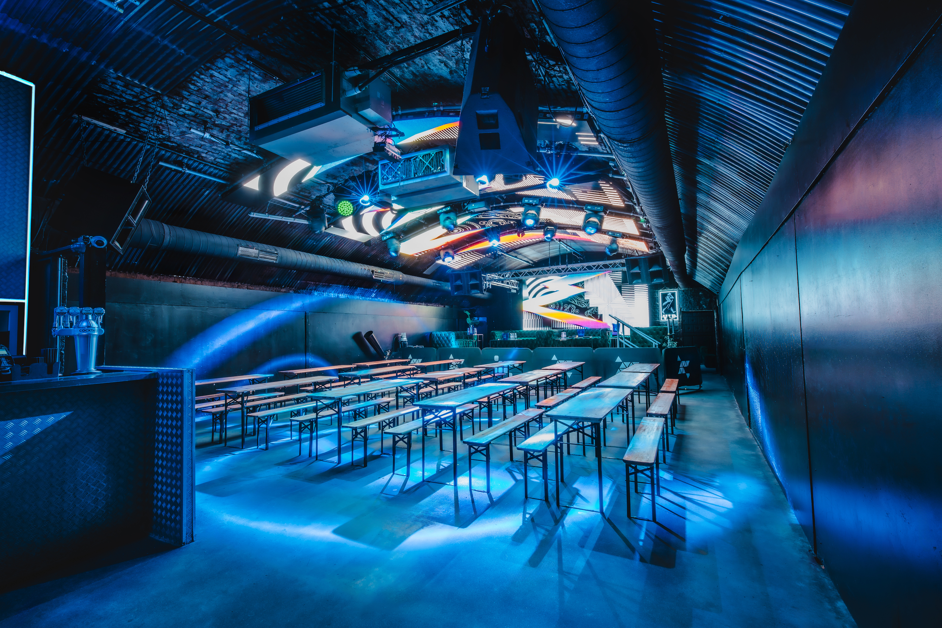 Fire Mirror Arch event space with communal tables for corporate and creative gatherings.