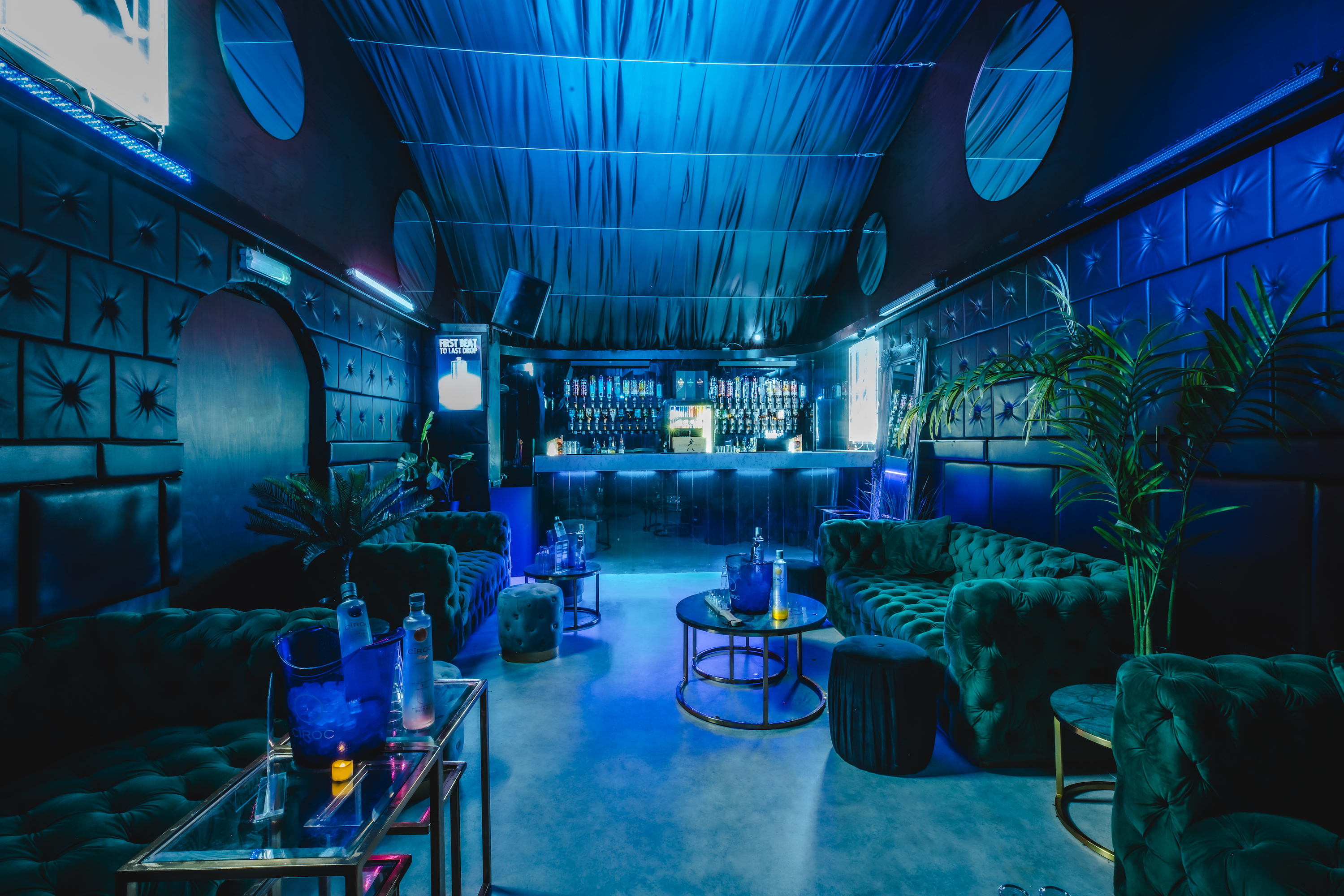 Fire Mirror Arch lounge with blue lighting, ideal for upscale events and networking.