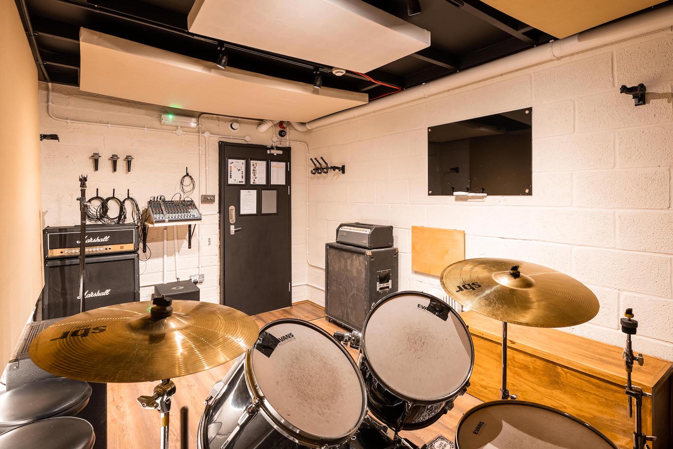 Yellow Hat Studios rehearsal space with sound equipment for creative workshops and events.