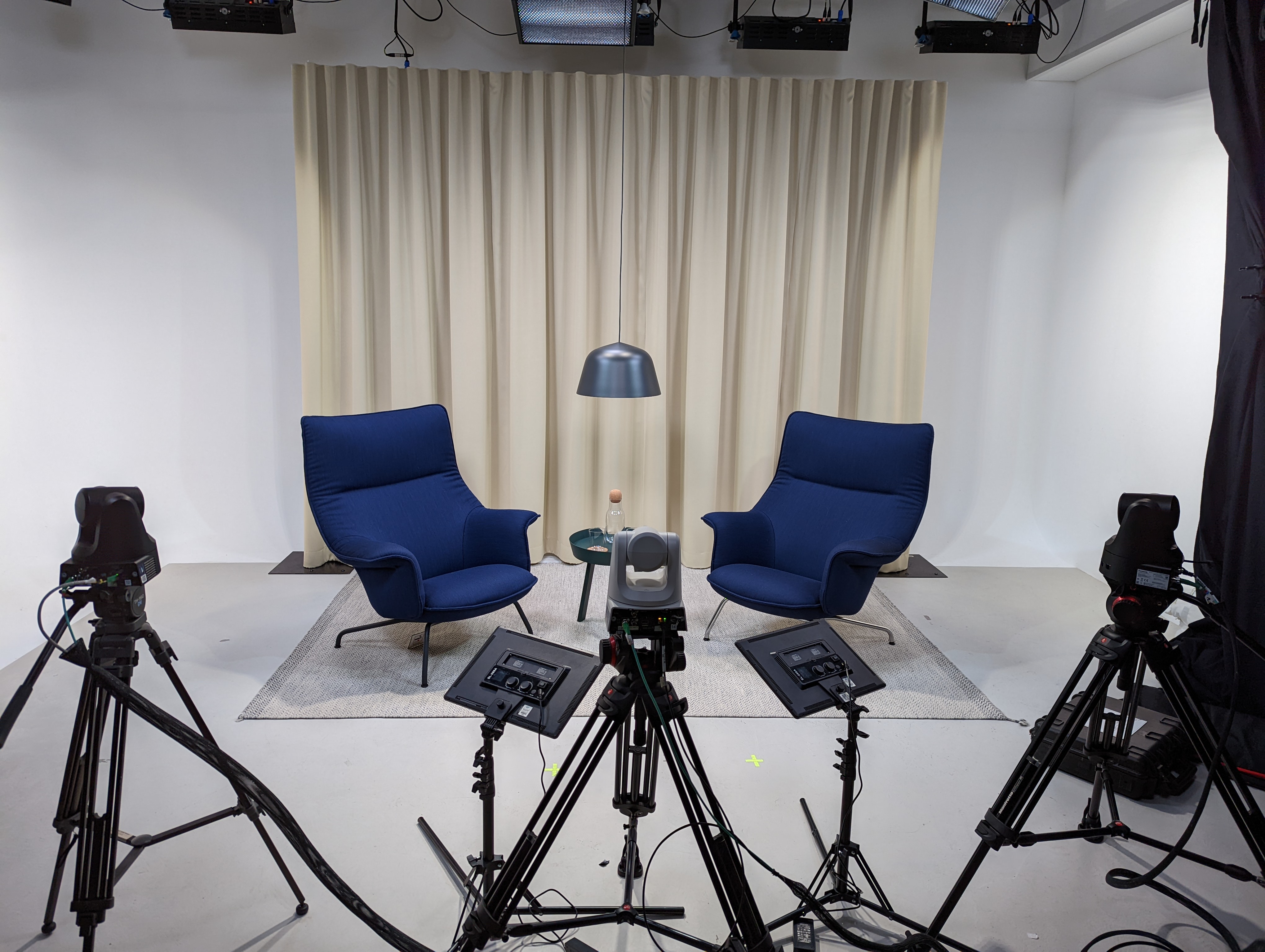 Great West Studio interview setup with blue chairs, ideal for virtual events and live streaming.