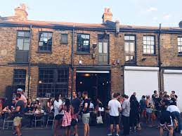 Vibrant outdoor gathering at rustic Wolfpack Lager venue, ideal for networking events.