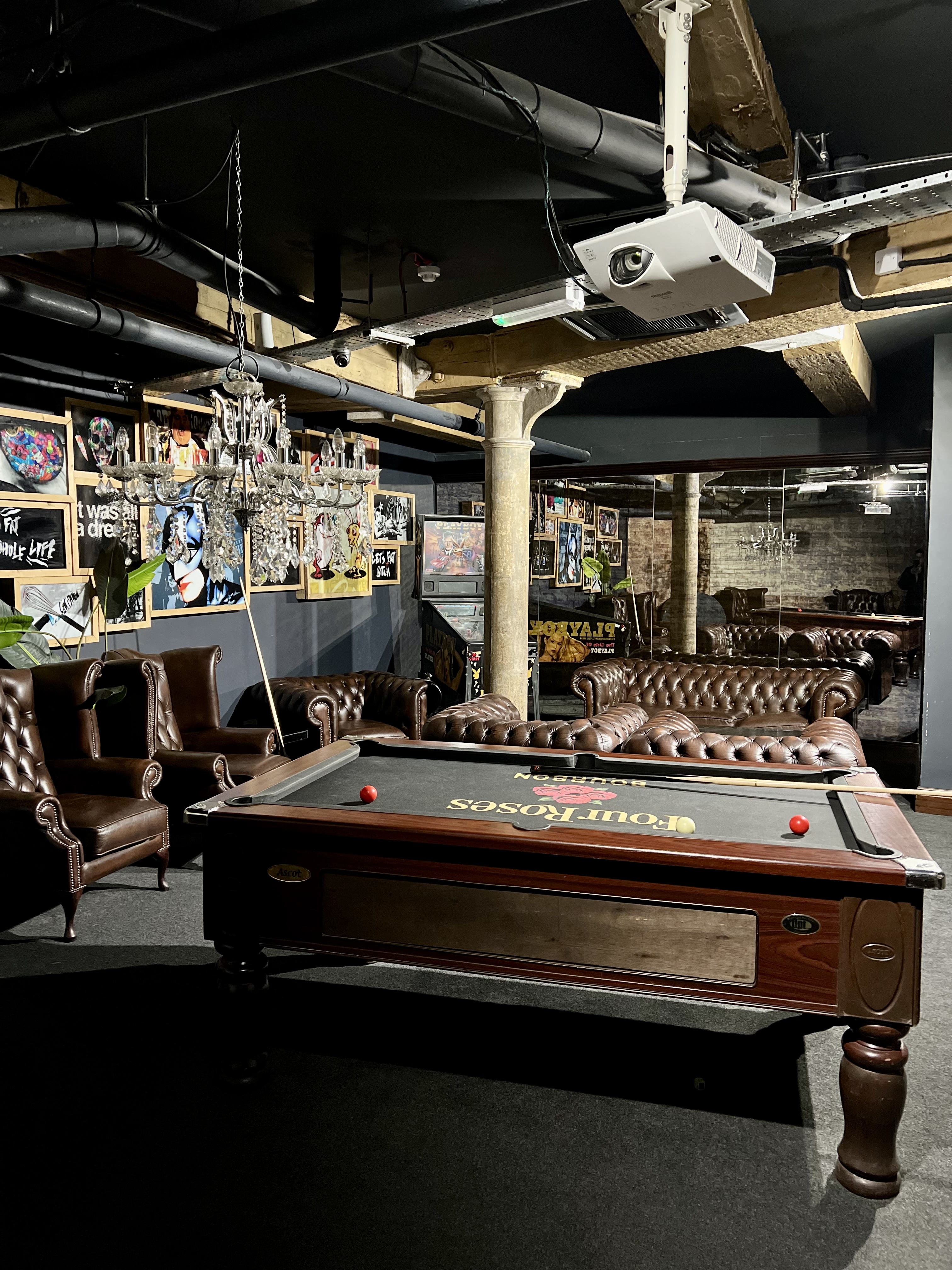 Stylish event space with leather seating and pool table for networking gatherings.