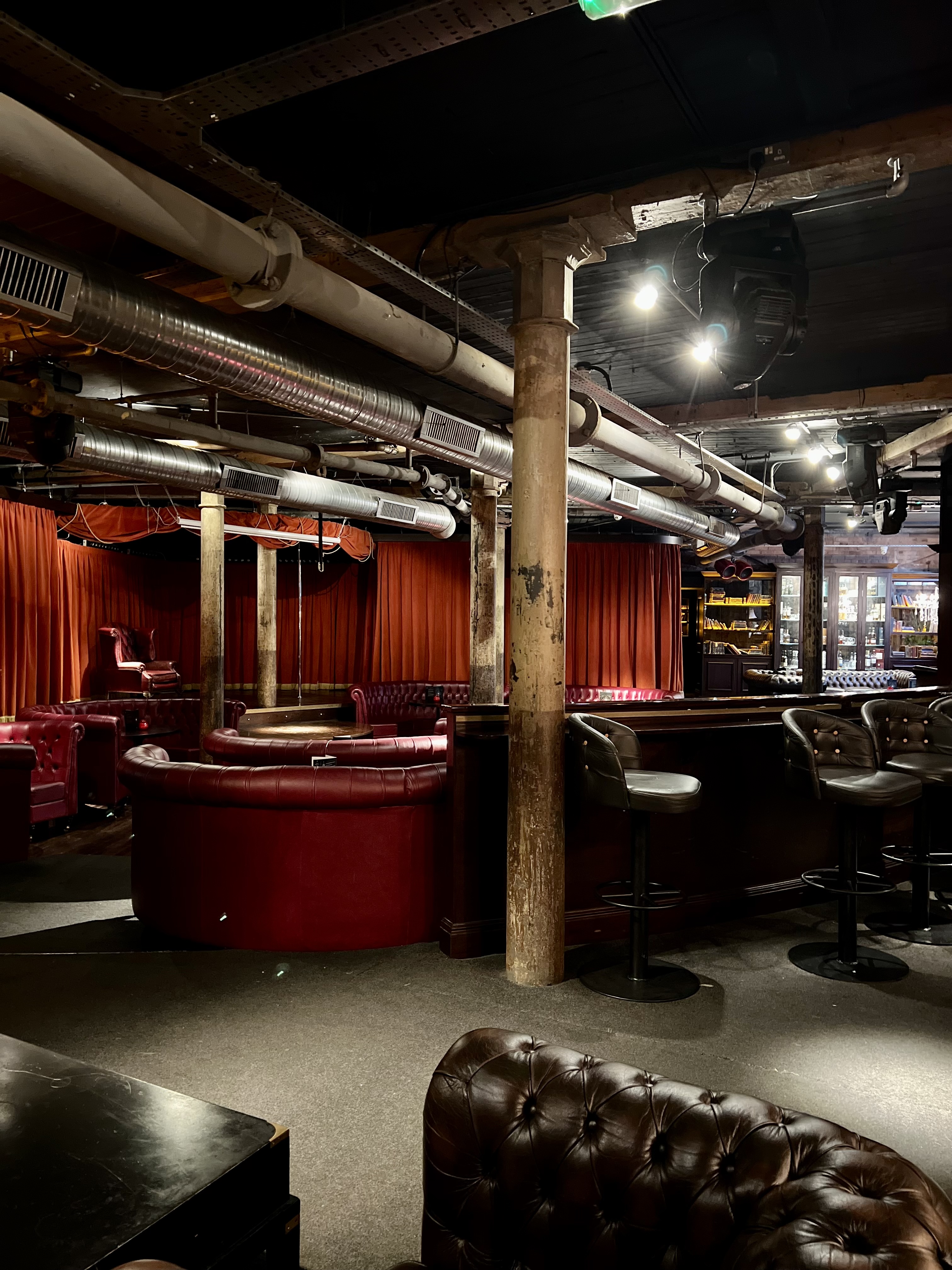 Stylish Main Floor in Whiskey Down with red curtains, ideal for private events and networking.