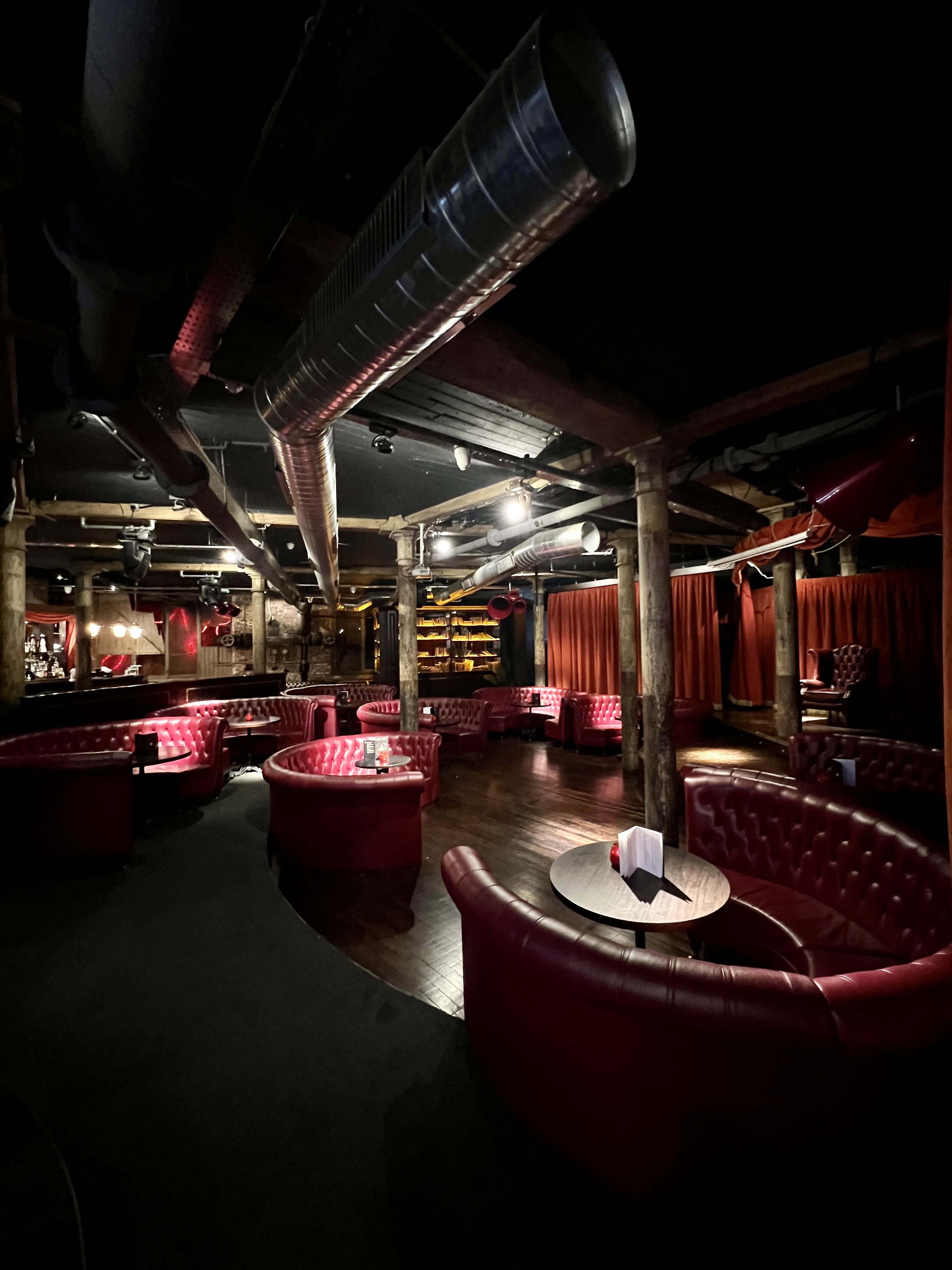 Stylish Whiskey Down venue with plush red seating for exclusive events and gatherings.