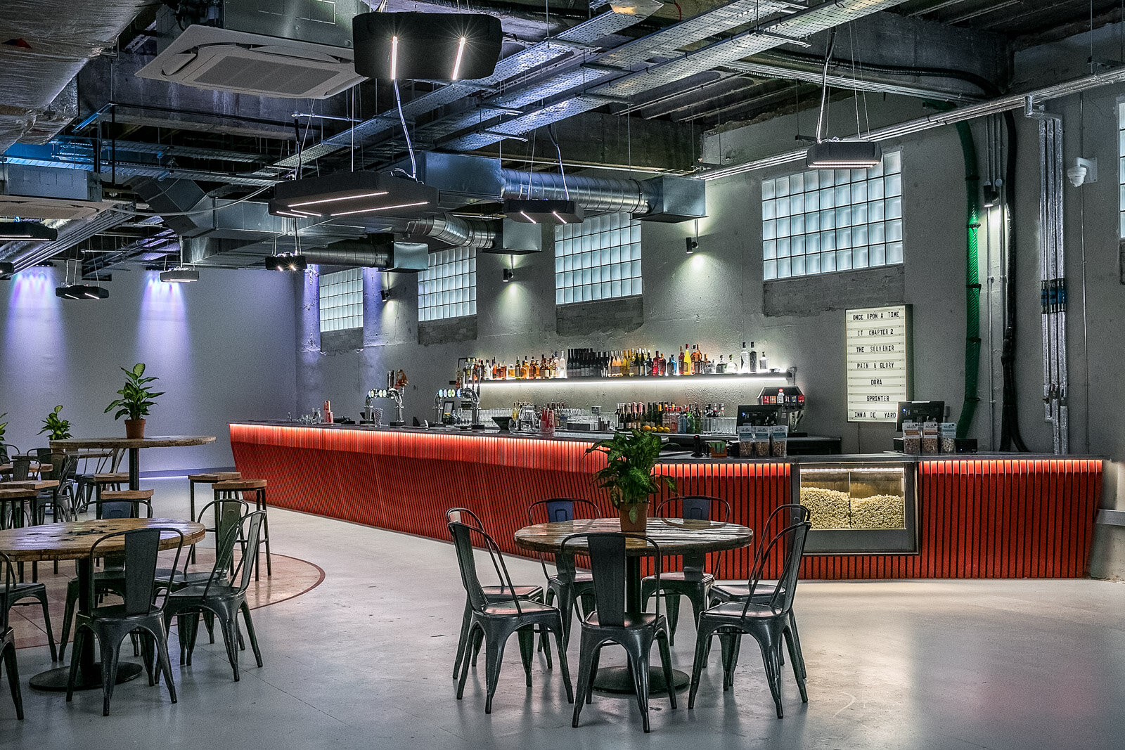 Catford Mews Foyer: modern event space with sleek bar, ideal for networking and gatherings.