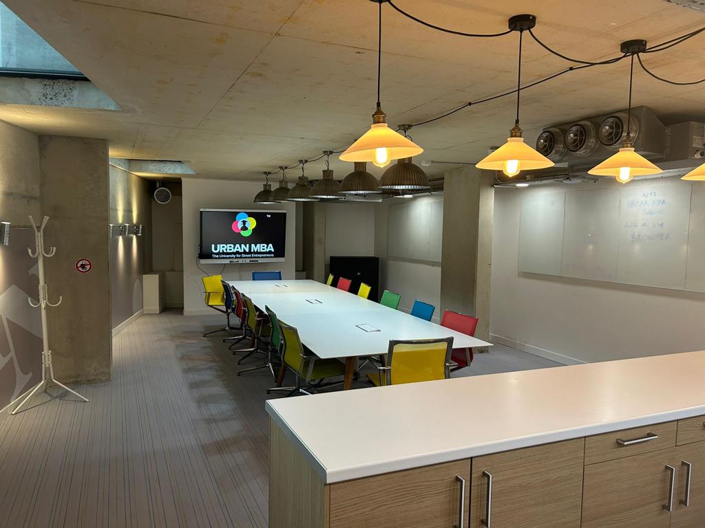 Modern meeting room with colorful chairs, ideal for collaboration and brainstorming sessions.