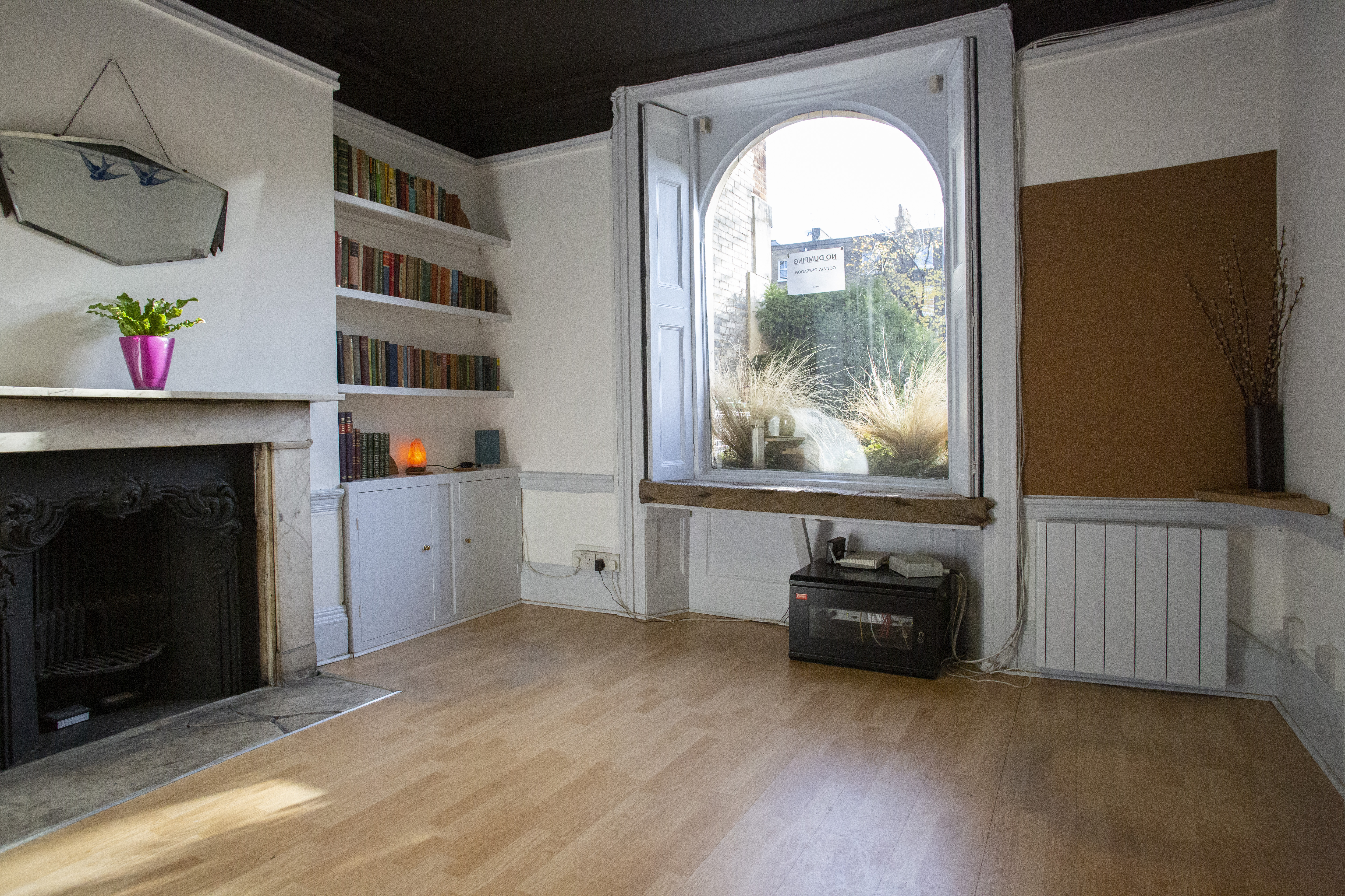 Cozy meeting space with large window, perfect for brainstorming sessions and workshops.