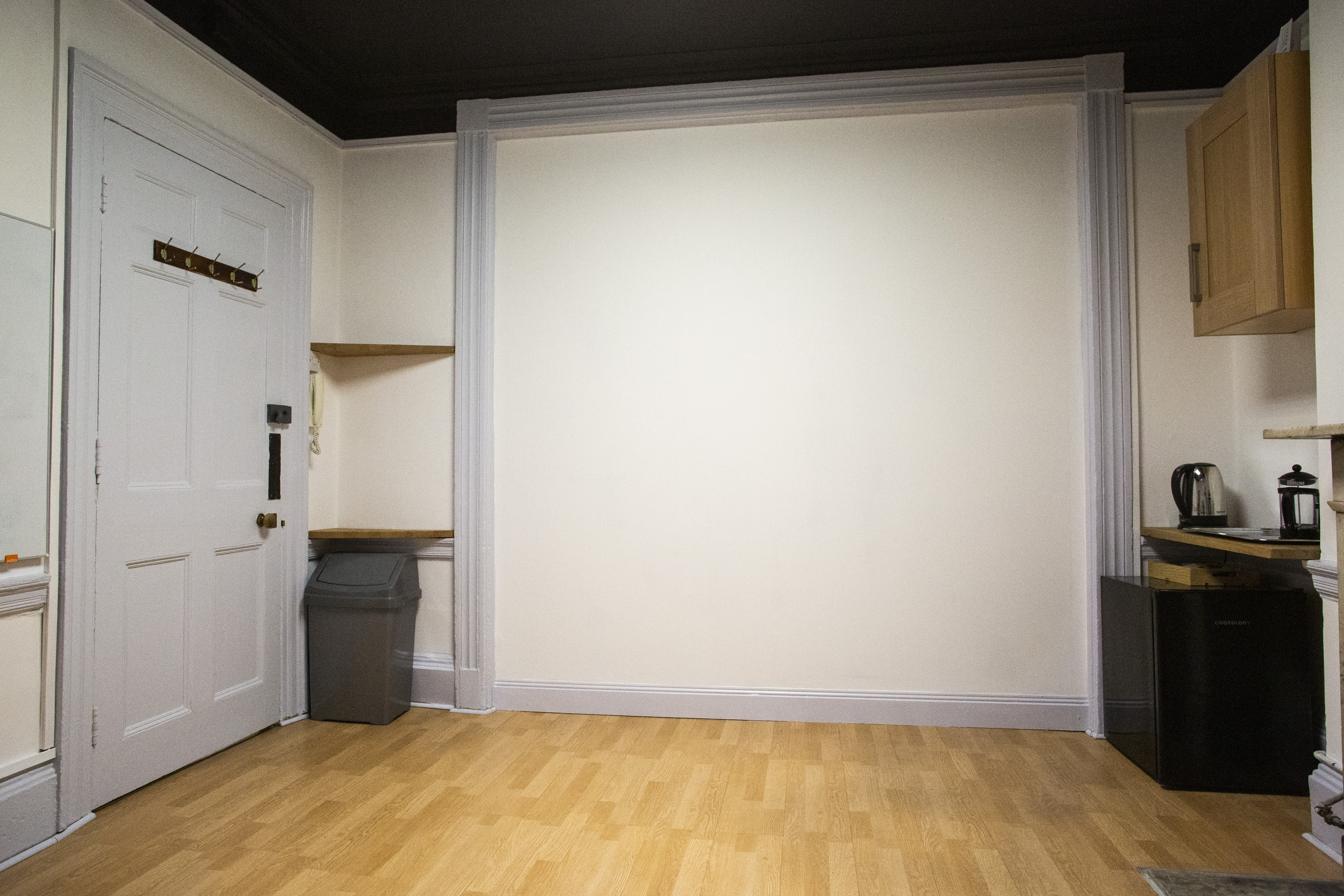 Minimalist meeting space with neutral walls, ideal for workshops and breakout sessions.