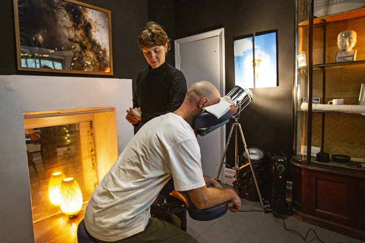 Chair massage at The Den in Anomalous Space for wellness conference relaxation.