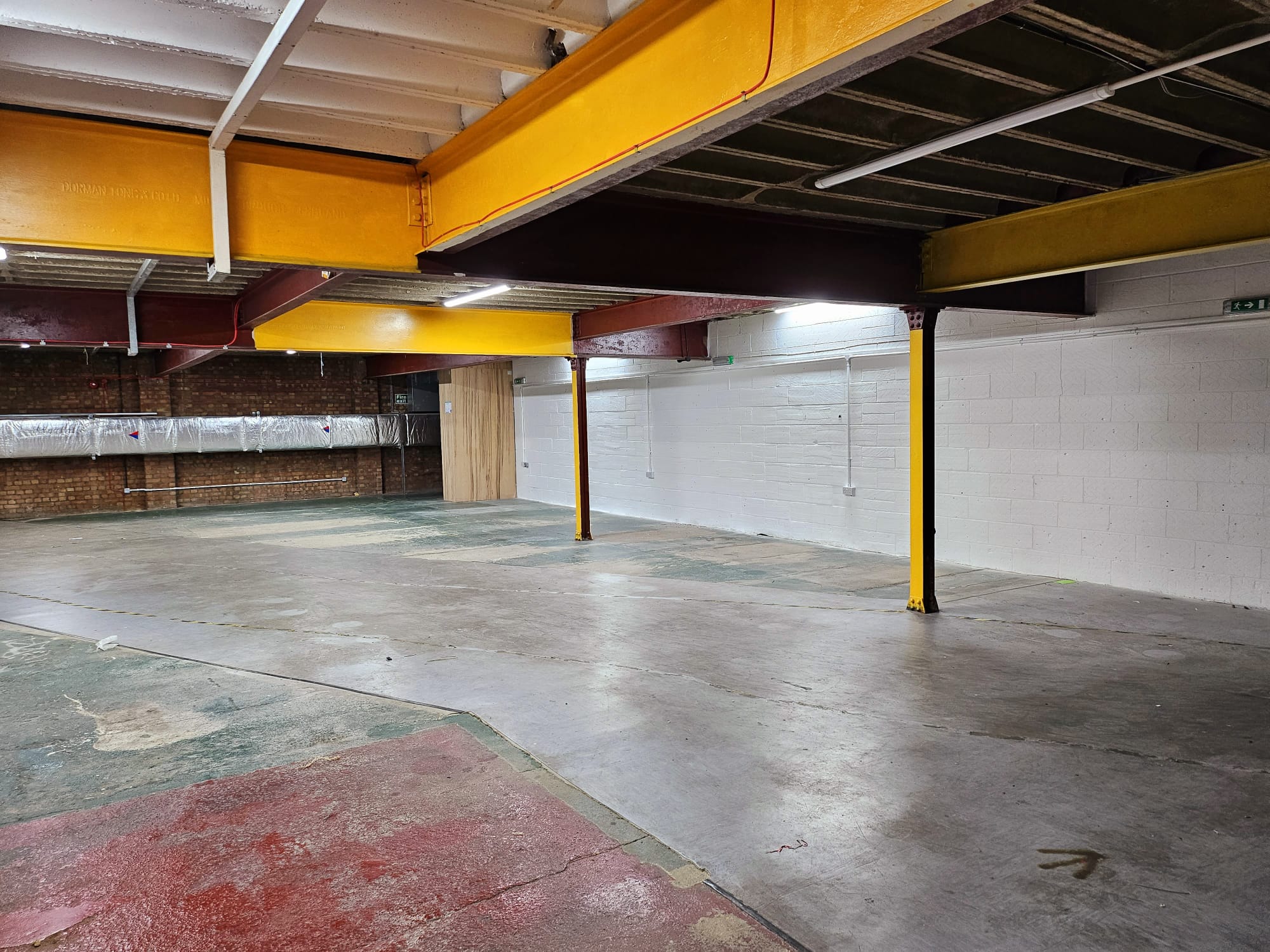 Spacious industrial venue with exposed beams for versatile events in Catford Mews.