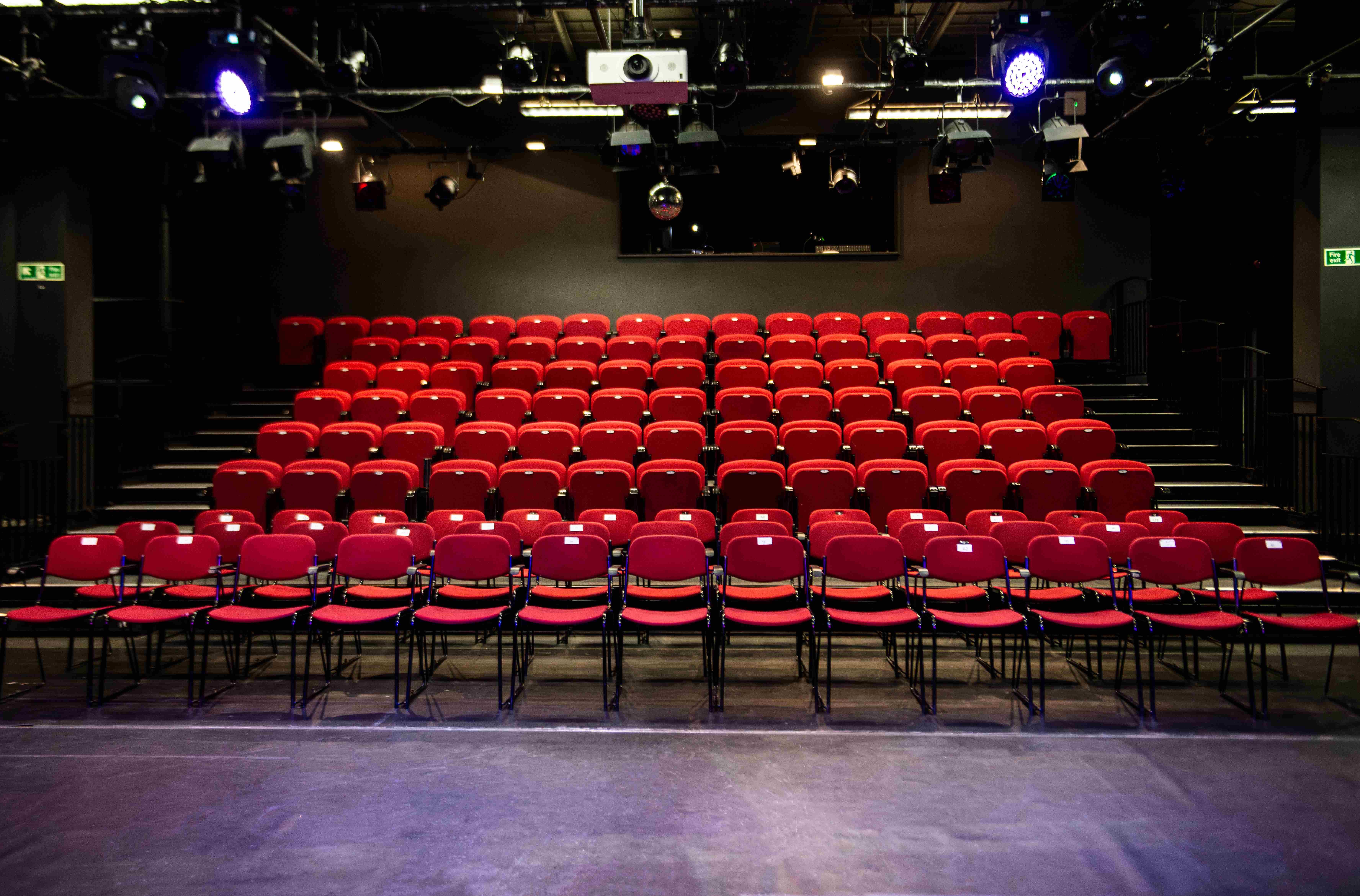 Dugdale Studio Theatre with red tiered seating, perfect for presentations and performances.