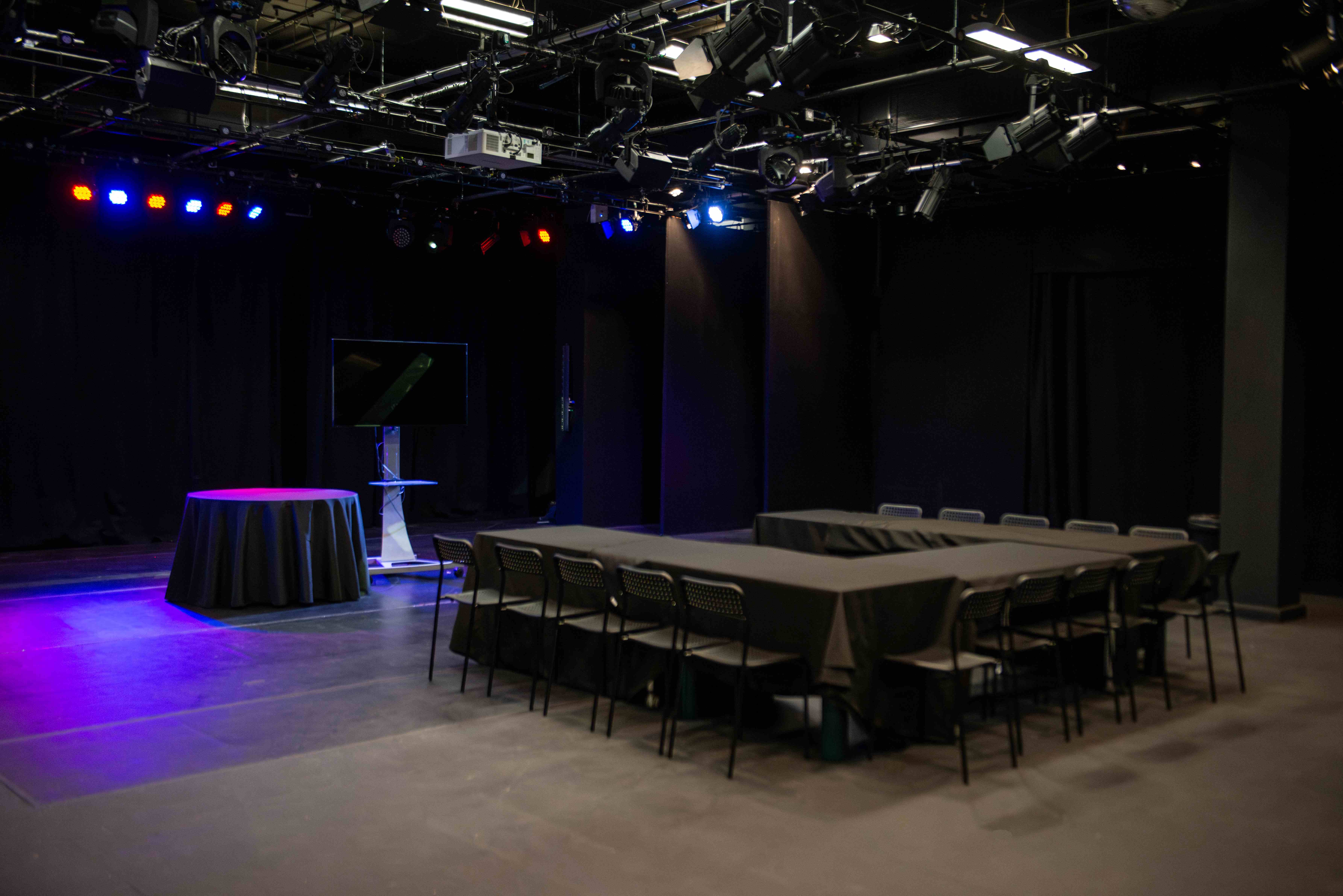 Dugdale Studio Theatre with stage lighting, ideal for corporate events and workshops.