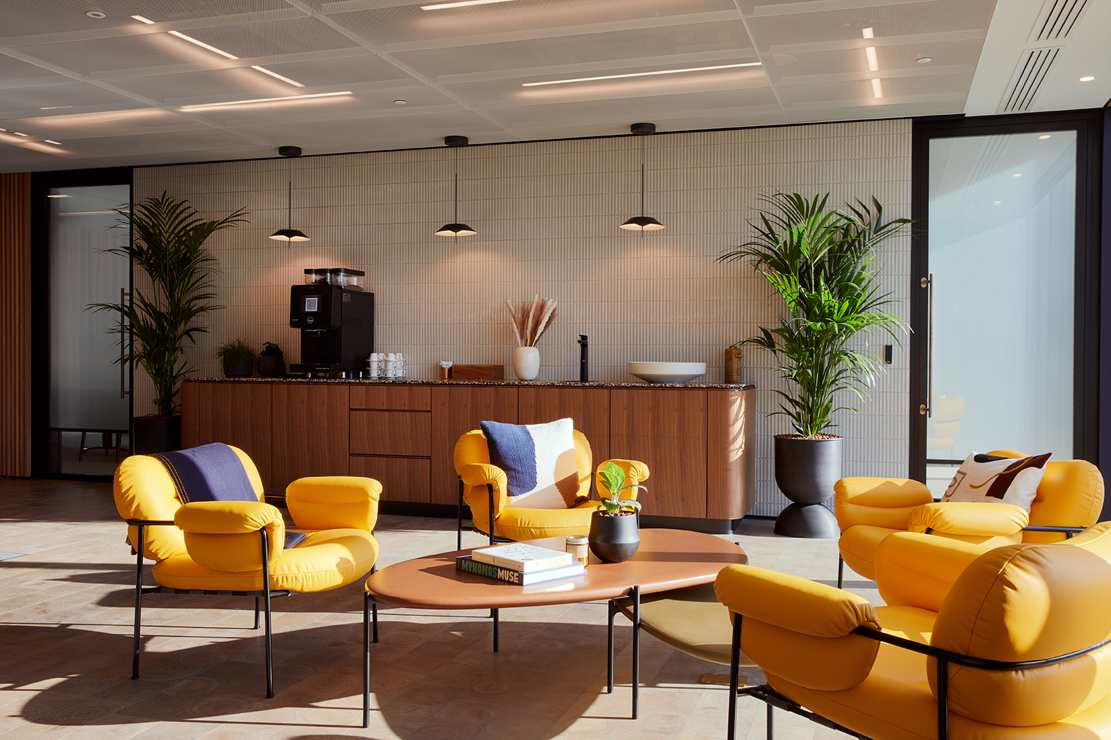 Modern lounge with yellow chairs for networking events at The Assembly, Myo Liverpool Street.