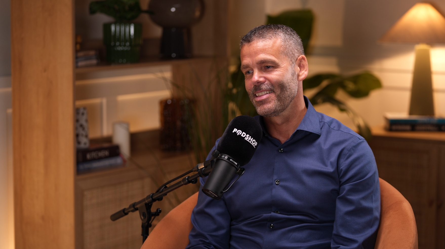 Podcast recording studio with soft lighting, ideal for interviews and content creation.