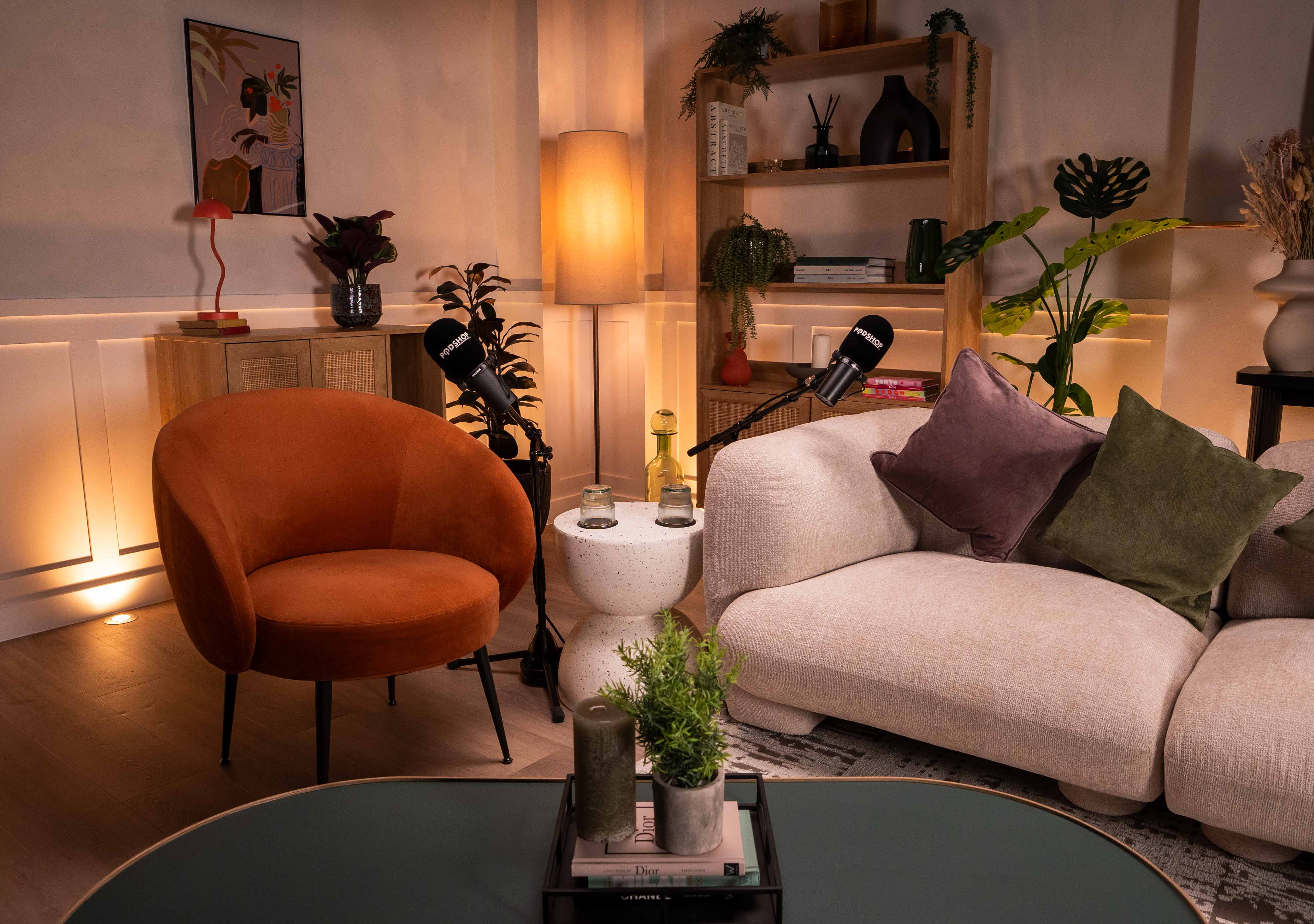 Cozy podcast recording studio with warm lighting, ideal for interviews and panel events.