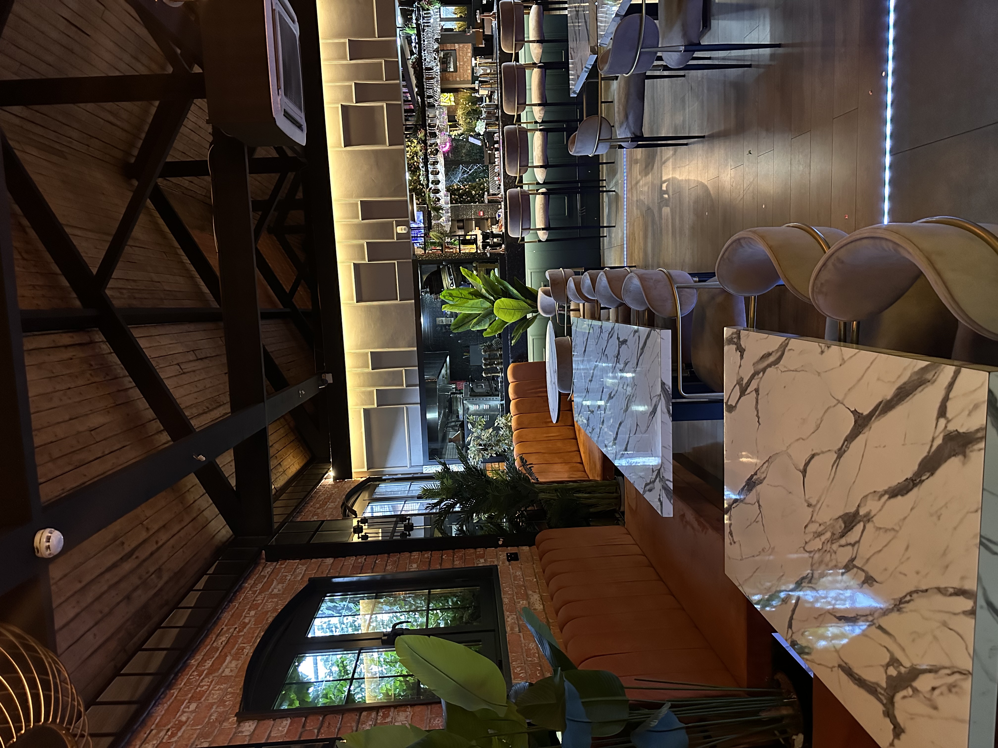 Stylish Ora Lounge with marble tables, ideal for meetings and social events.