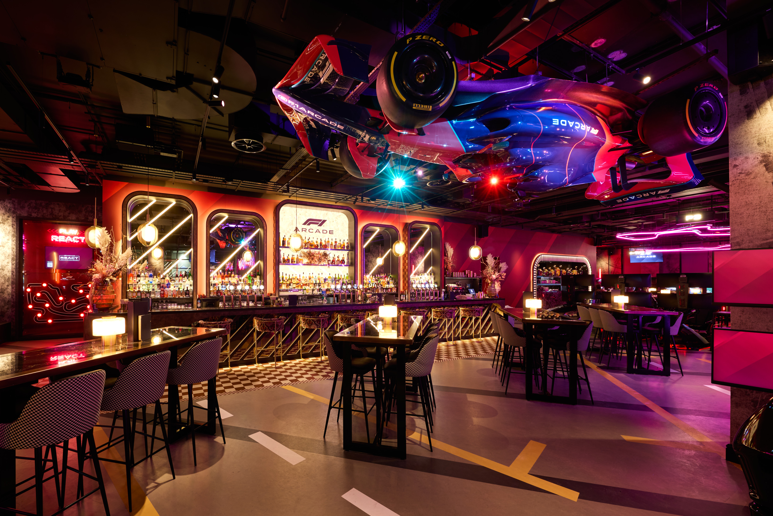 Full Venue Hire at F1 Arcade Birmingham with suspended Formula 1 car, ideal for events.