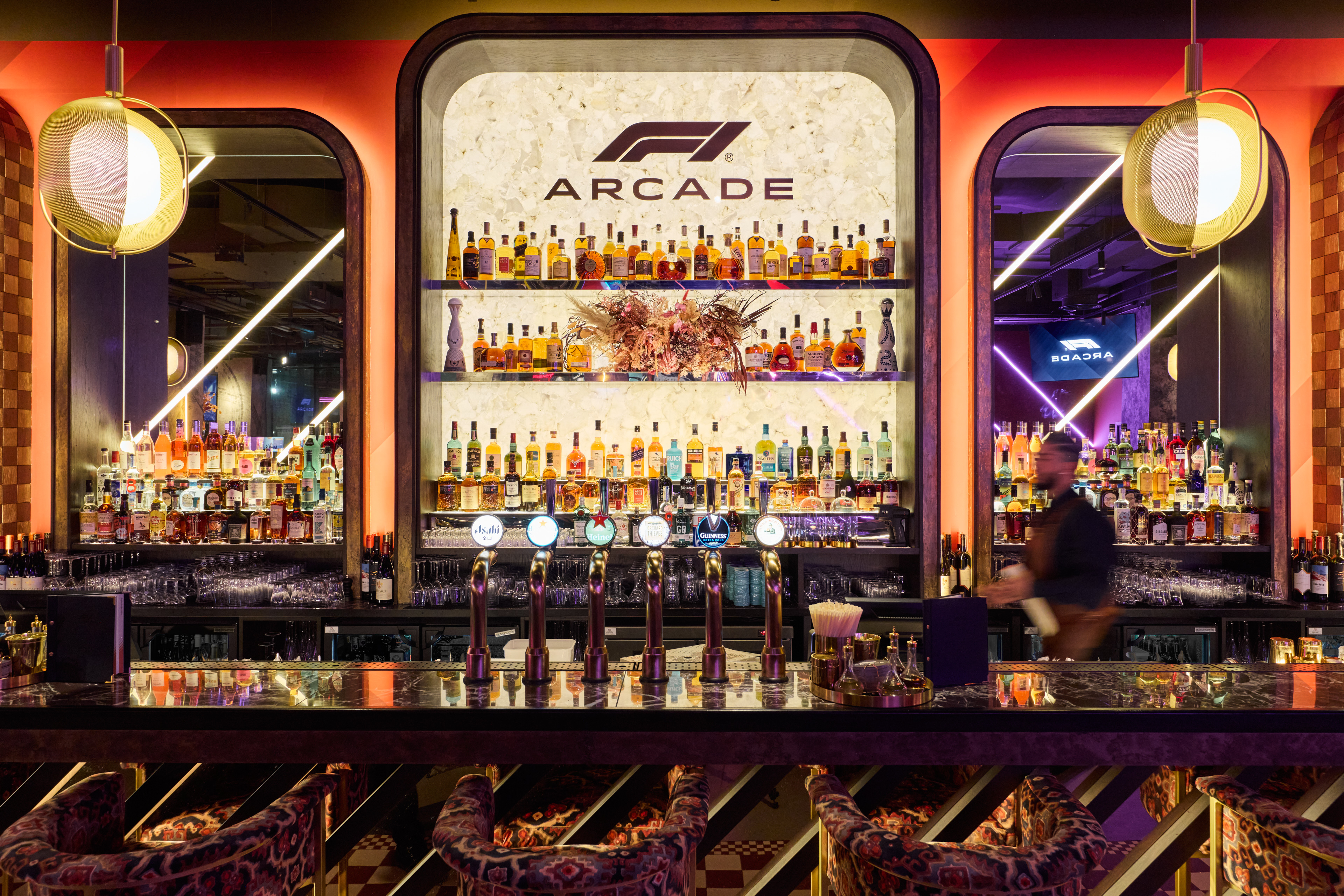 Vibrant F1 Arcade bar area, perfect for upscale events and networking in Birmingham.