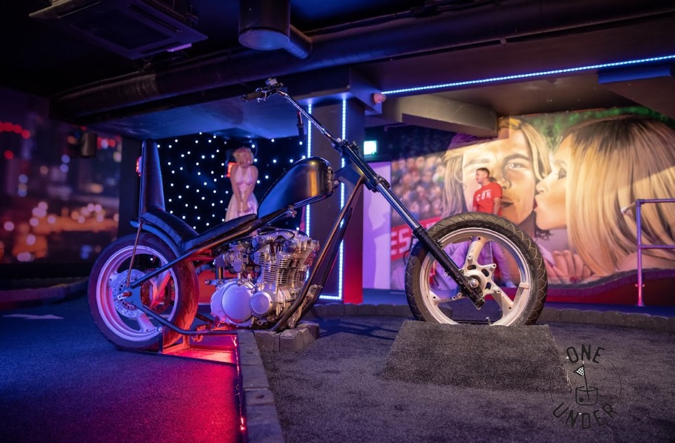 GlasVegas event space with striking motorcycle centerpiece and vibrant murals in Glasgow.