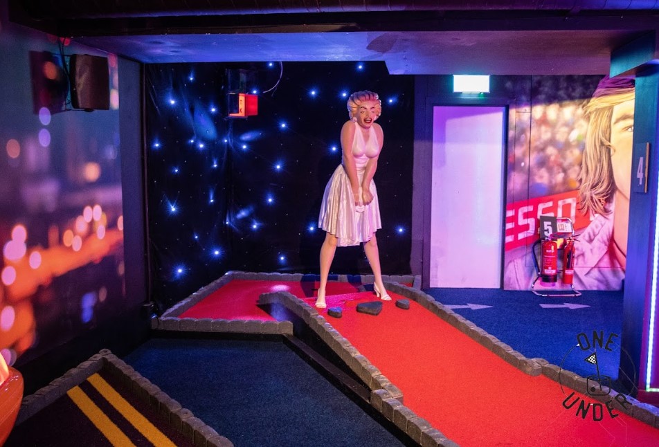 GlasVegas mini-golf in One Under Glasgow, vibrant decor for corporate events.