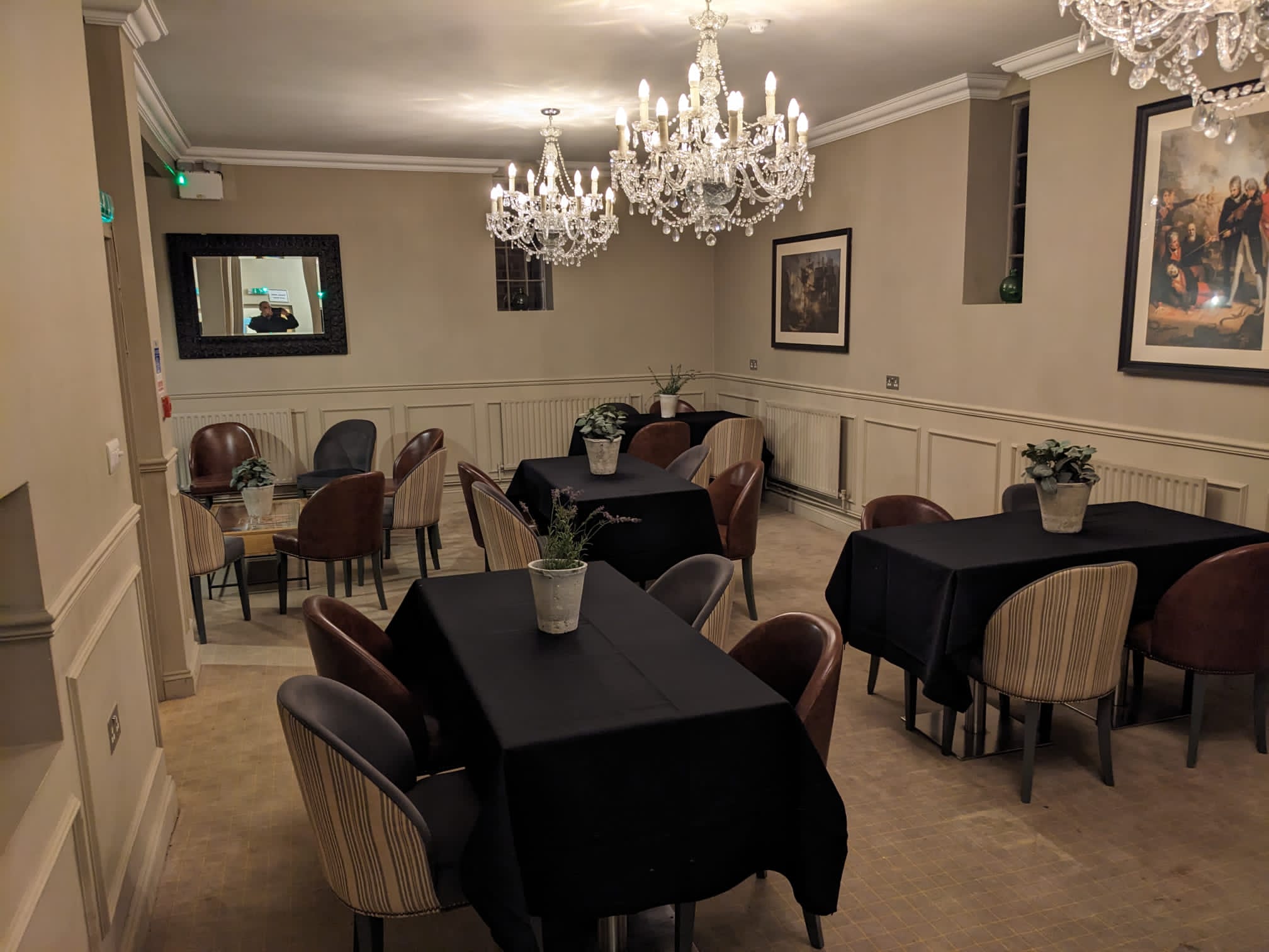 Elegant meeting space with chandeliers for intimate corporate events and workshops.