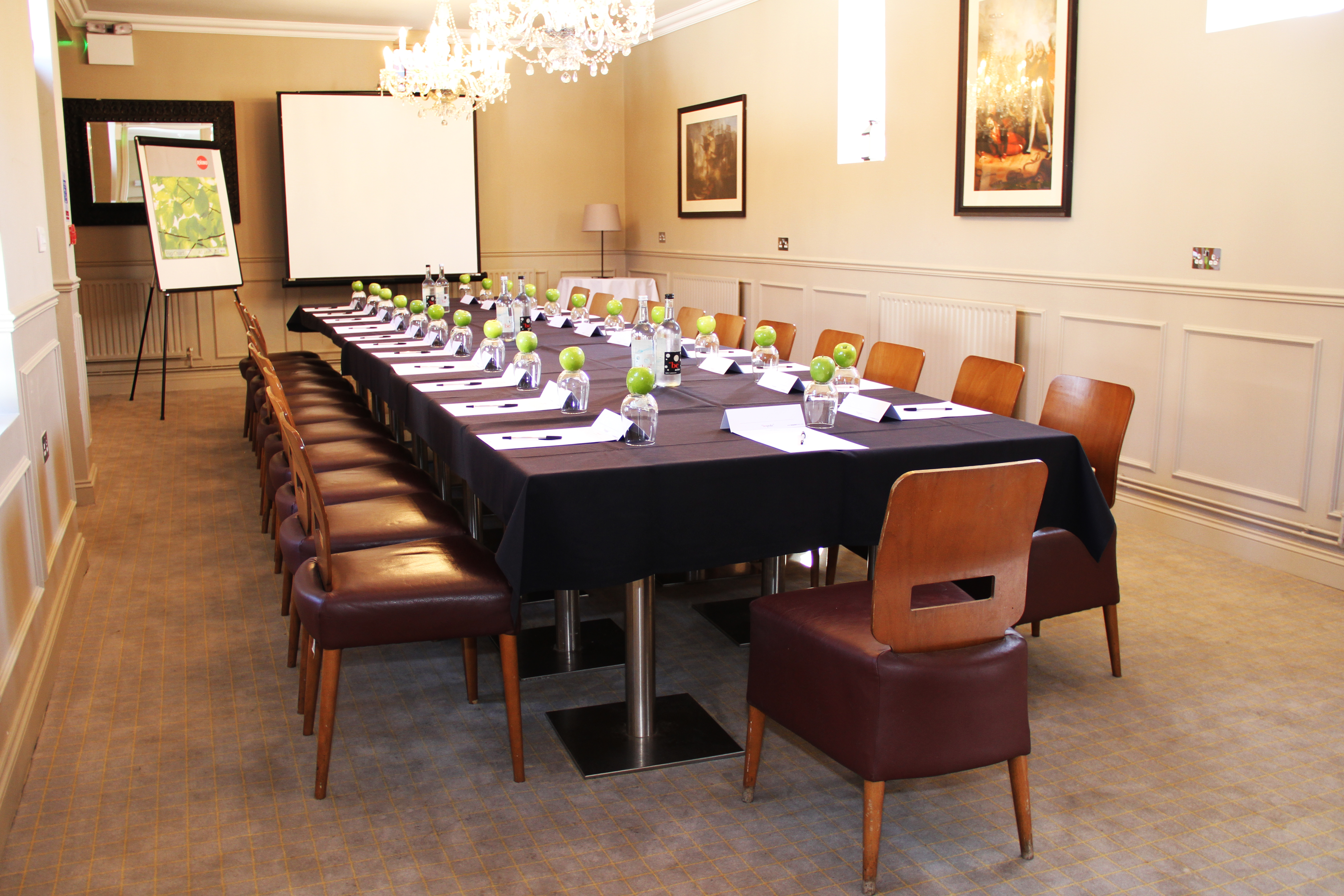 Meeting room setup with elegant table, notepads for corporate events and gatherings.