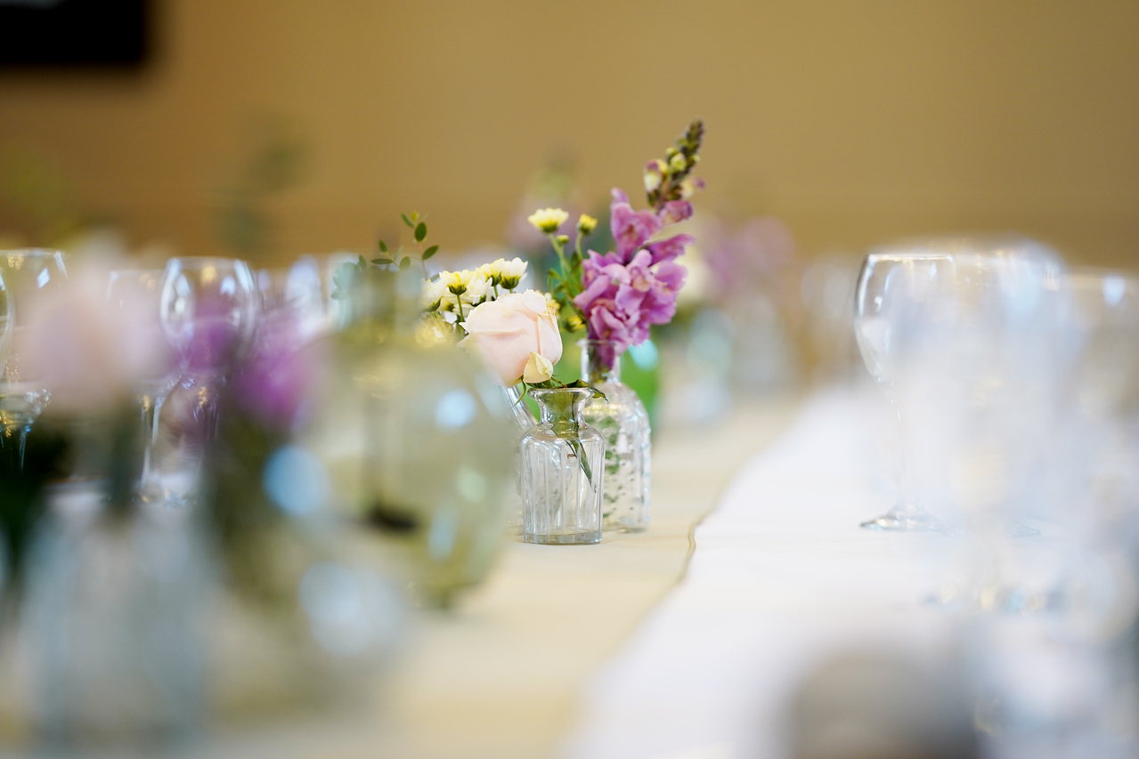 Elegant table setting with floral centerpieces for a wedding or formal event.