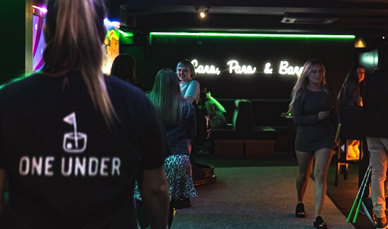 Vibrant Mad House venue in Glasgow with neon signage, perfect for social gatherings.