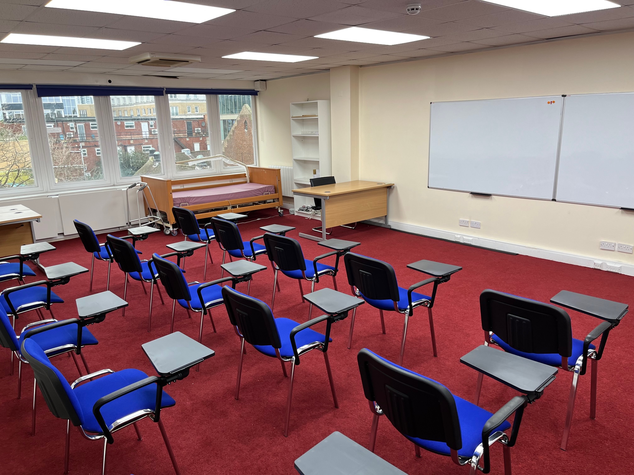 Training room in Whitechapel with blue chairs for workshops and meetings.