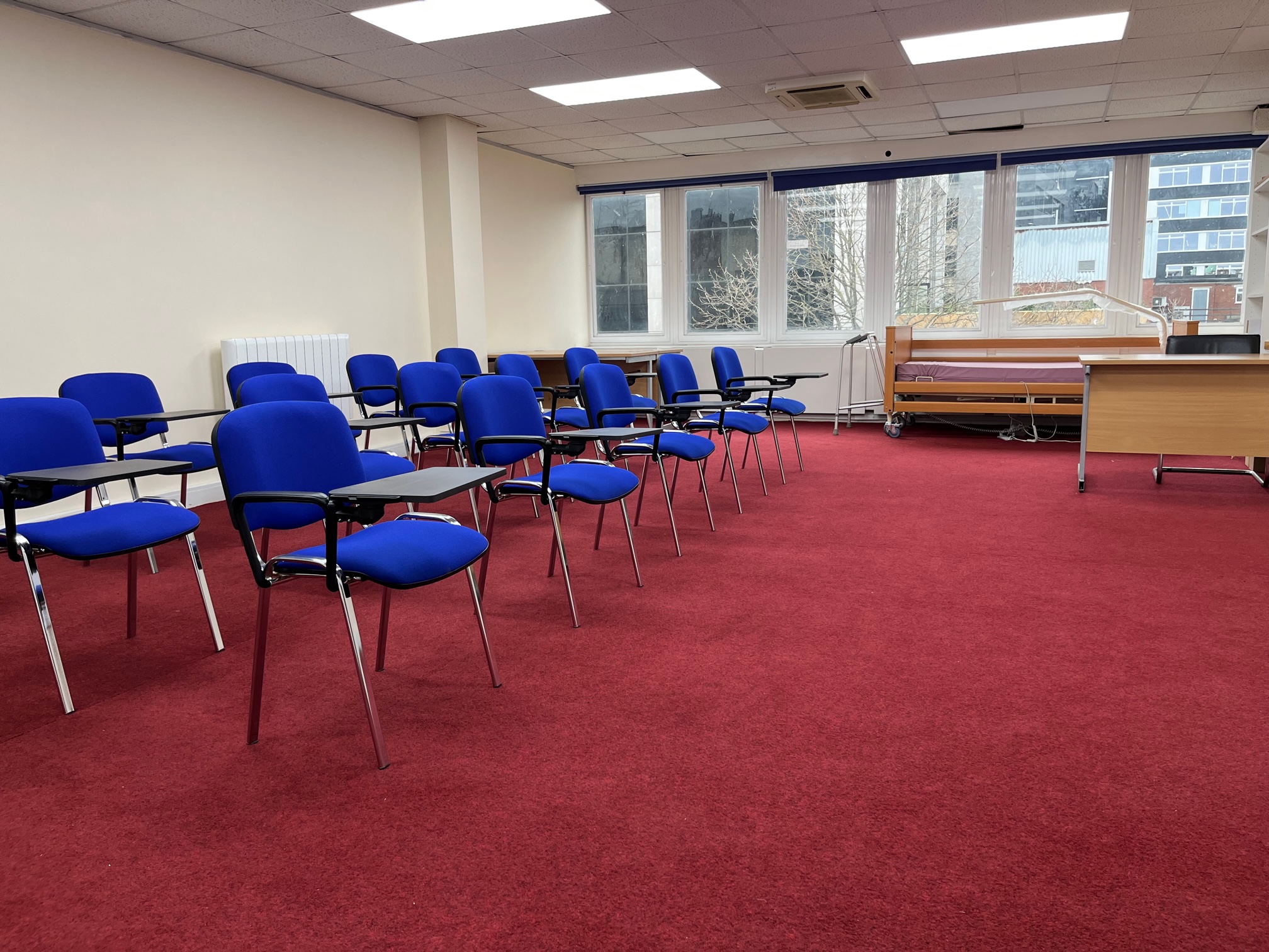 Training room in Whitechapel with blue chairs, ideal for workshops and meetings.