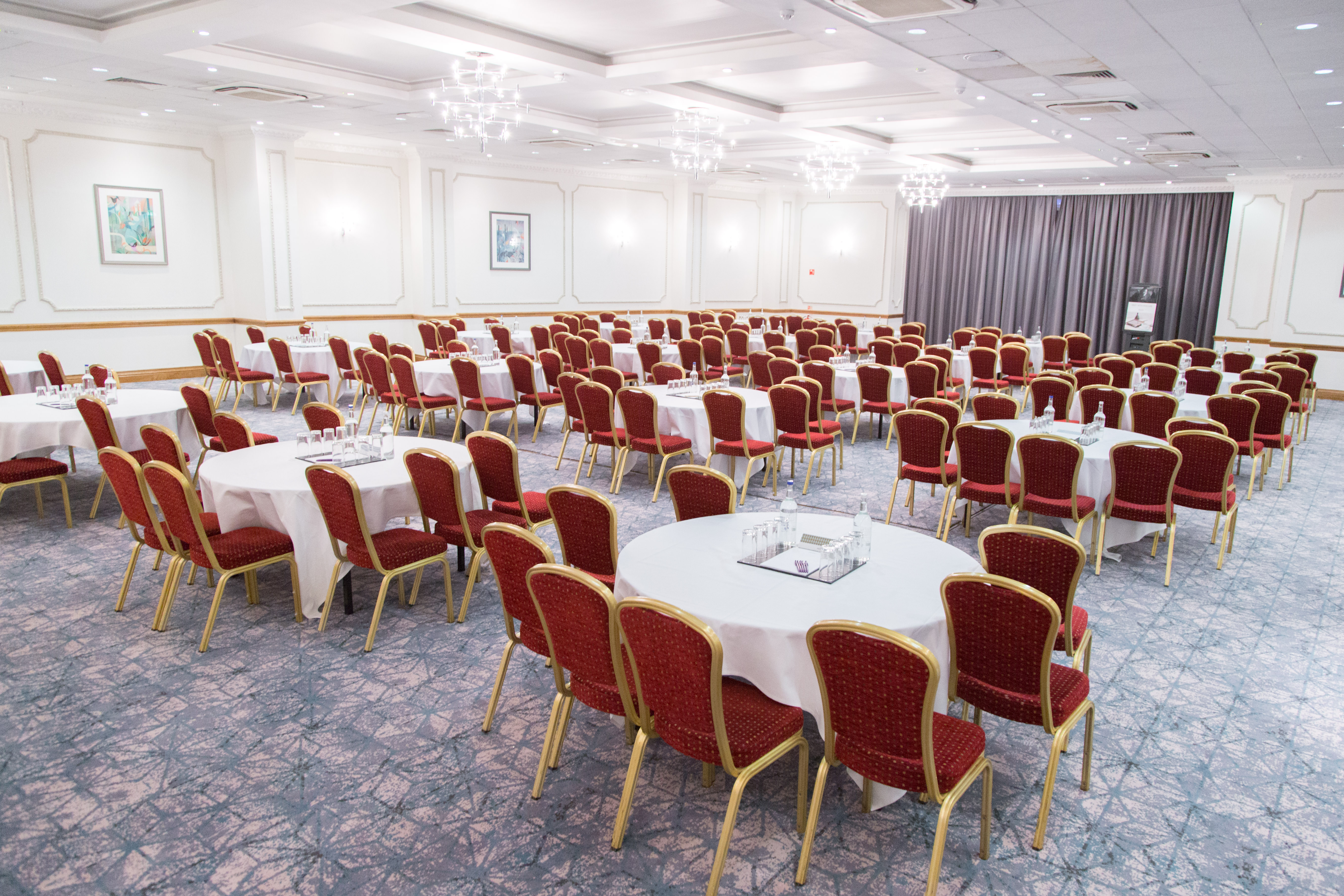 Wessex Suite banquet venue with round tables, ideal for conferences and networking events.